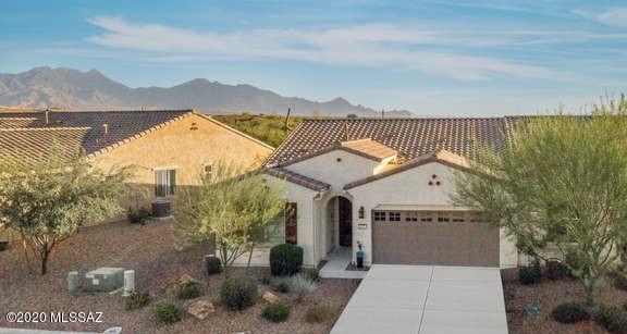 MAGNIFICENT mountain views from this stunning 3 year old Villa in Quail Creek.Spectacular setting, provides privacy with no back neighbors with beautiful desert and mountain views. 2 BR/ 2 BA + Den w/ glass french doors for privacy and light exposure. Many designer updates including gorgeous cherry cabinets with under & over cabinet lighting, decorative backsplash and quartz countertops, SS appliances, ceramic tile, upgraded lighting, new custom security door, plantation shutters, ceiling fans, epoxy garage floor, on an exceptional VIEW lot. HOA covers all exterior maintenance so you can travel worry-free as your home will be maintained in the gated community of Quail Creek.Built in 2017, you'll enjoy this home's beauty inside and out!  Furniture available.