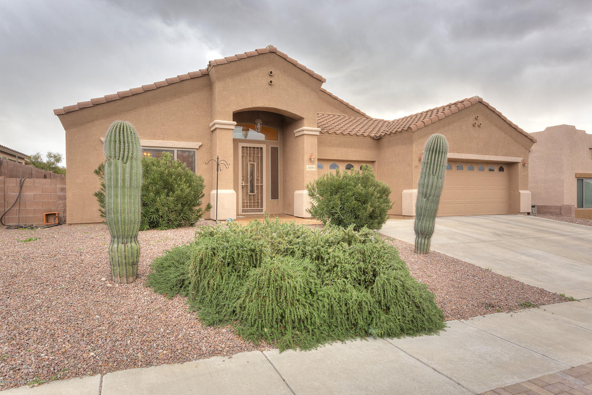 Elevate your lifestyle in a gated community with city & mountain views! This spacious single-story home w/ salt-water pebbletec pool is just the ticket!  The beautiful tiled floors extend through all living areas w/ new carpeting in the bedrooms only. Great floor plan offers so much space, including formal areas up front, huge great room, walkthrough laundry area, one accessible bedroom & bathroom, large master suite plus two other bedrooms & sky-high ceilings. Beautiful natural hickory cabinets, granite counters, plantation shutters, ceiling lights and fans in most rooms are just a few of the nice features waiting for you. The garage is extended 4' & includes an access door plus built-in cabinets. The backyard includes a turf area plus a lovely  pool w/mtn & city views, backs to wash!