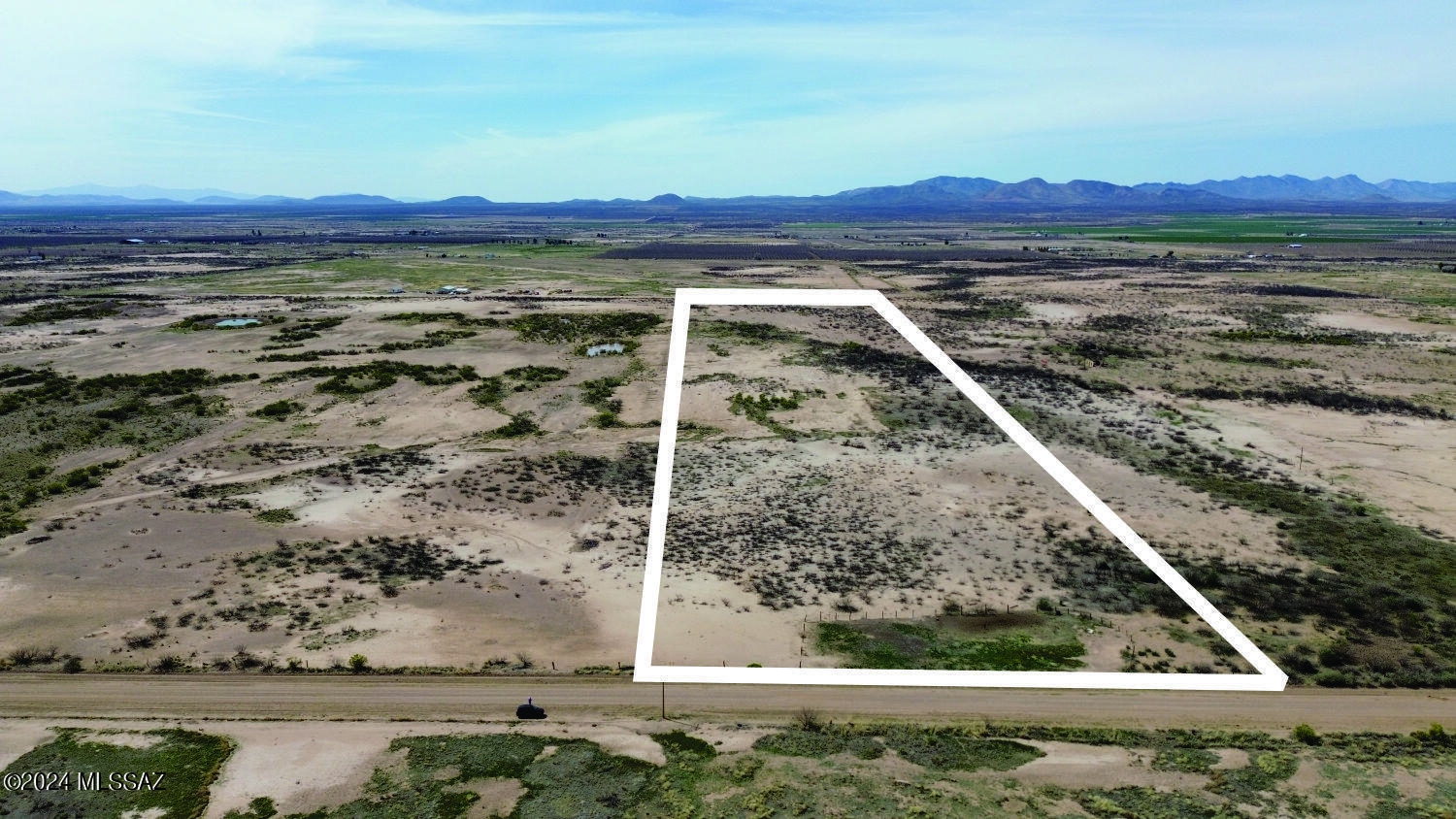 Flat rural property where you can bring your horses or other livestock. Live in peace watching the sunrise and sunsets. Electricity is across the street.  Seller will finance with $4,900 down with balance over 10 years. Don't miss this chance to own your Arizona dream.