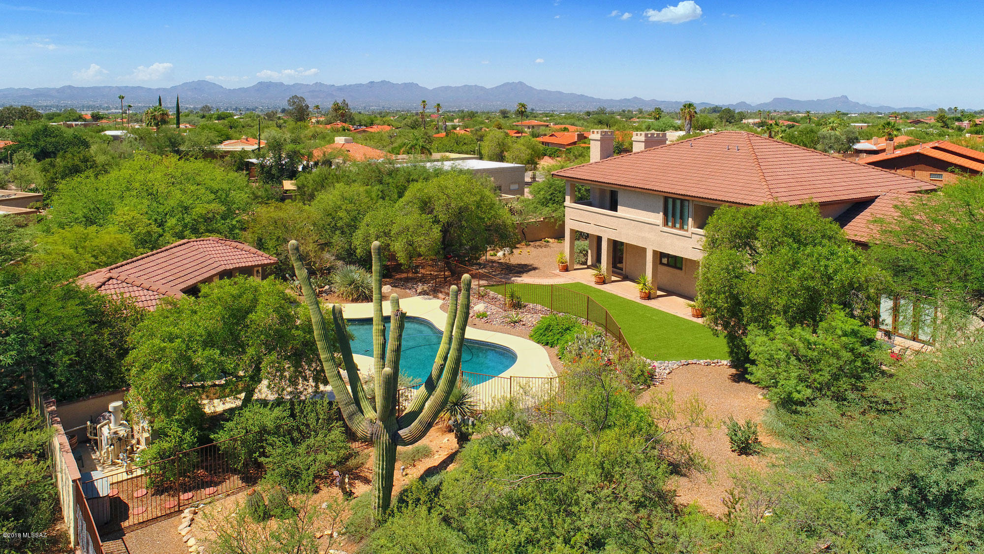 Elegant and grand yet cozy and comfortable traditional style home on beautifully manicured approximate ¾ acre lot with courtyard entry, fabulous rear yard with patios, ''no-care lawn'', pool, spa, ramada and Gas BBQ stub. You will enjoy life in the sprawling custom ''600 plus home'' Foothills Neighborhood of Shadow Hills, so convenient to shopping and dining at La Encantada or River and Campbell, award winning schools, the U of A and the Downtown Arts and Cultural scene. Entertain in style in the wainscoted living room with soaring ceilings, fireplace and dual French doors flowing from front to back patios. Cook for your family or a large gathering in the gourmet island kitchen with granite countertops, Sub-zero fridge, large pantry, breakfast bar, dry bar, desk and large breakfast nook looking out to the lovely yard and pool area and cozy family/TV room with fireplace. The large bedrooms you seek are all on the second floor and enjoy sweeping Mountain and Valley Views from all windows and two balconies, including one off the Master retreat with fireplace, walk in closet and master bath with dual vanities and jetted tub. Three car garage, ample storage, including huge laundry room won't disappoint. Be sure to check out the Matterport 3D Tour under the photos tab on MLS.