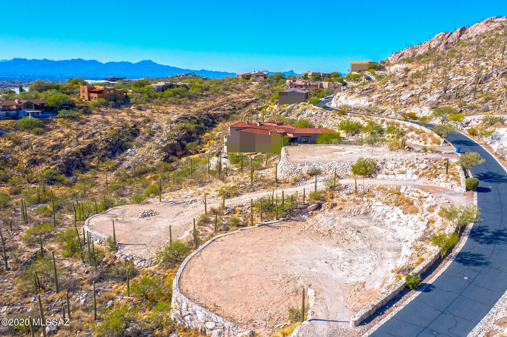 Lot 47 in the ESTATES AT FINGER ROCK For Sale in the FOOTHILLS of Tucson, AZ!  Nice graded flat pad ready to go. Beautiful rockwork retaining wall. This is in the most premier GATED neighborhood in the Tucson Foothills. UNBELIEVABLE VIEWS!! of the CITY and MOUNTAINS! Located in north central FOOTHILLS at the end of Alvernon Way. Easy access to popular hiking trails at Finger Rock. All utilities including sewer, water, and power service the lot. Close proximity to fine dining, and shopping at La Encantada and others. This is 1 lot of 15 available by the same developer/broker. Ask Broker for a price sheet. See the touch screen Interactive Virtual Tour For a Birds Eye View!!