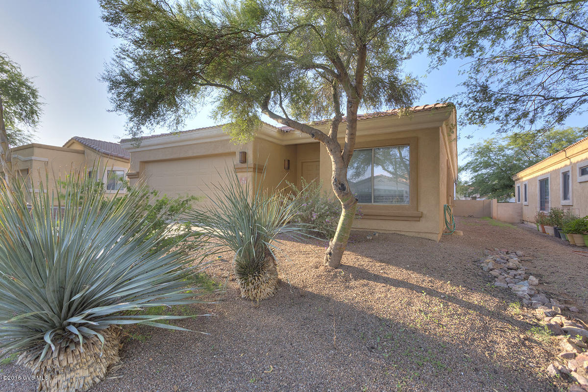 Single story 4BR home in Gated neighborhood offers added privacy & security in Arizona's favorite master planned community of Rancho Sahuarita with private water park, pools, fitness center, bark park, hike/bike trails & more. Great community activities with special seasonal events, movies under the stars, toddler story time, Farmers Market, open air concerts and more. This spacious 4BR 2BA home offers both formal & casual living areas in a single story split floor plan. Immaculate condition. Interior and EXTERIOR recently painted. Easy care hard flooring surfaces throughout. Newer appliances included. Backyard adjoins common area for added privacy. Come experience the lifestyle of Rancho Sahuarita - it's ALL in your back yard!