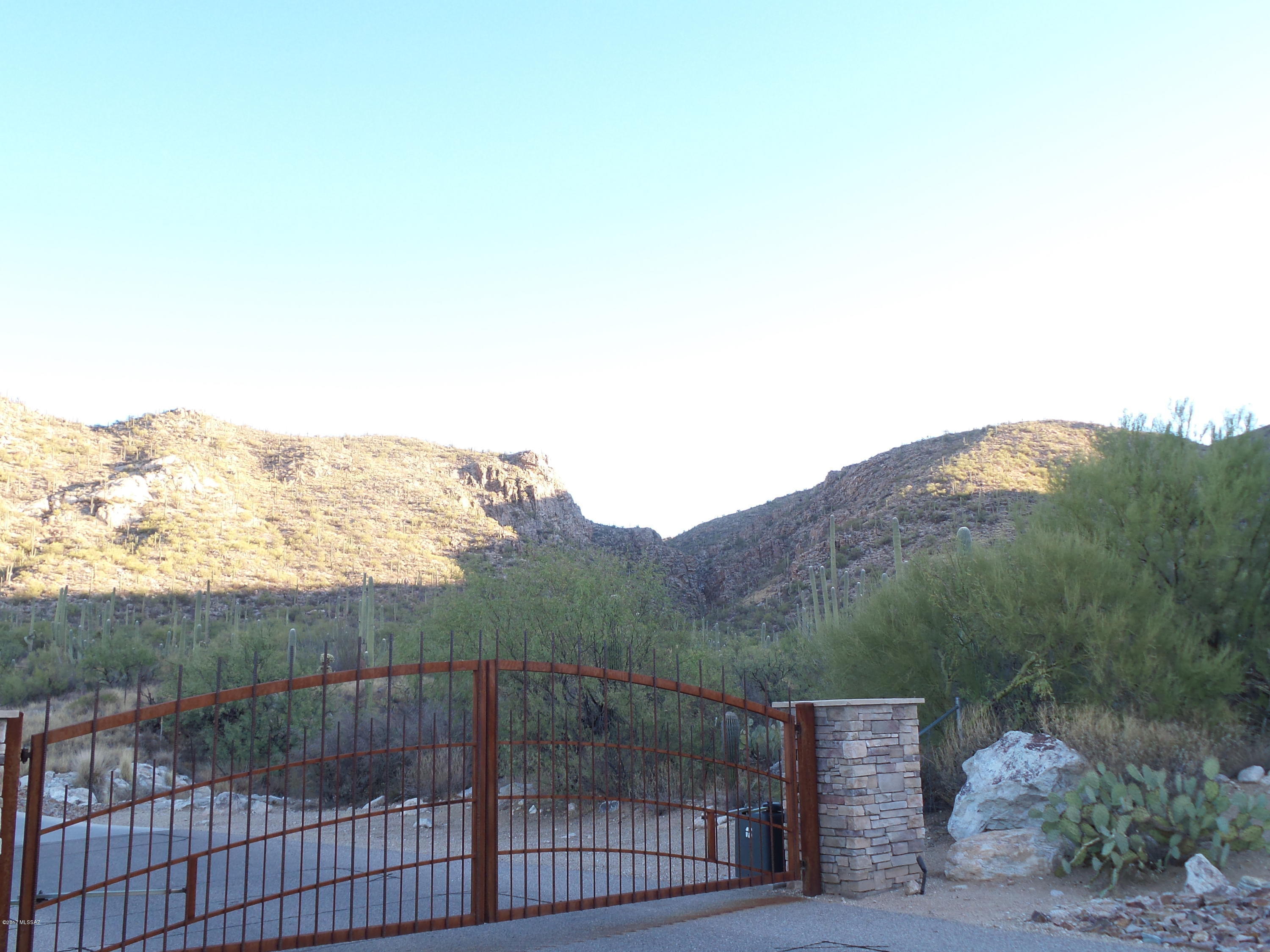 This is a rare opportunity to be located just steps from the Coronado National Forest in a private gated enclave of just four lots in the Tanque Verde Valley. Fantastic views of the Tucson Valley & both the Catalina & Rincon mountains. In the morning you can watch the rising sun & the canyons begin to be illuminated. At dusk you see the mountains change colors to pink & then purple. As the sun sets behind the Tucson Mountains, from this elevated lot you can view the painted sky & then city lights to the west. All utilities to the lot with a water meter already set saving thousands in development cost. Flat topography for easy building. Many saguaros dot the natural lush vegetation. Area homes above $1,000,000. Just minutes to 49ers Country Club & area shopping. This lot is priced to sell!