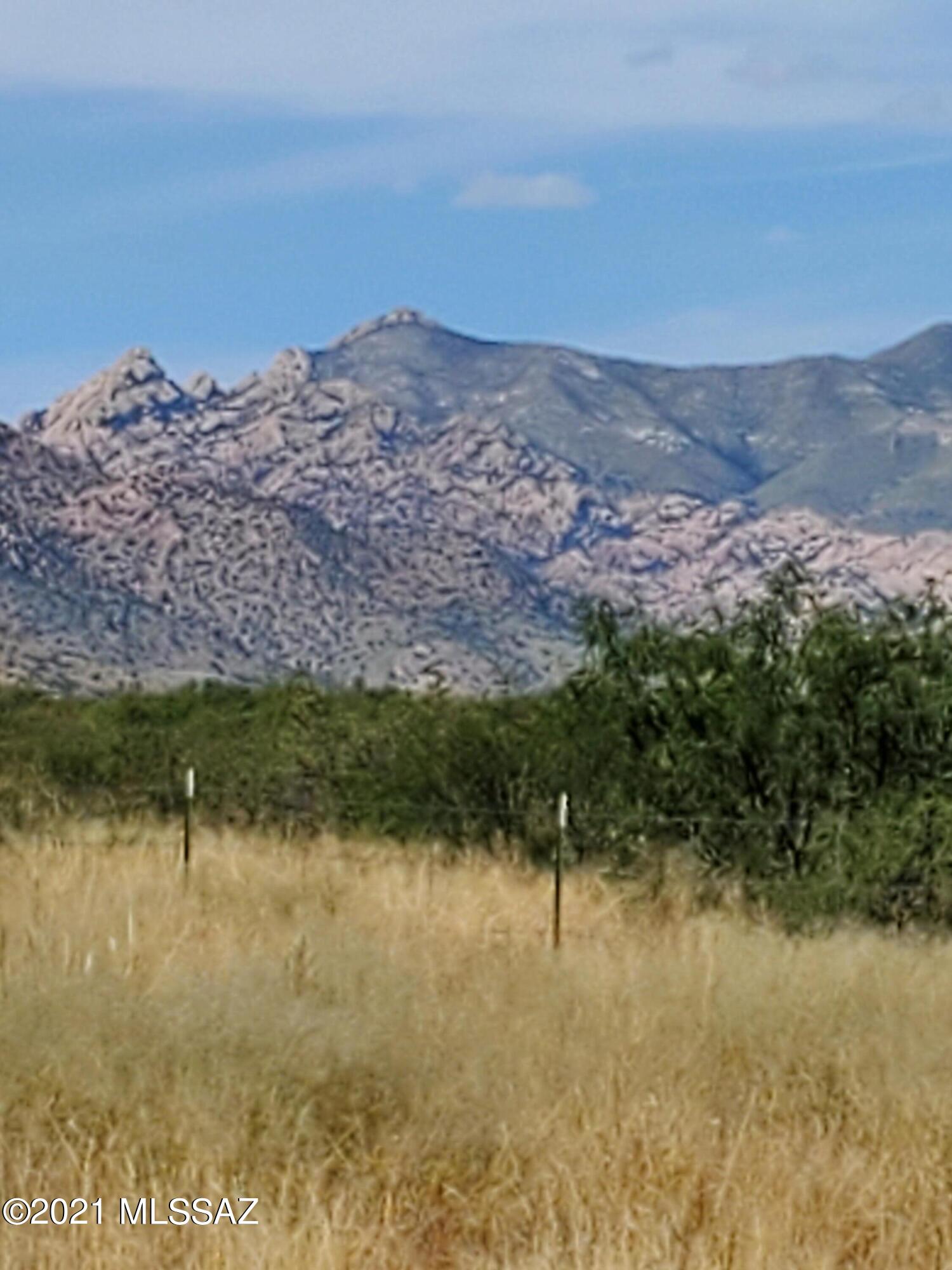 Not just Vacant land! 360 degree views of the valley and mountains. Seller has put a lot of work into this nice property. Land was mostly cleared and is beautiful grass land. The property has two gates and is partially fence and cross fenced. there is an existing lavender garden area plus 3 moringa trees. plantings are watered by irrigation system from a 250 gallon holding tank.  Seller hauls water as needed. 12 x12 shed is like new with a metal roof and is powered by Solar Panels. Has lights, fans and Alarm system. Rural, Quiet Country home site.