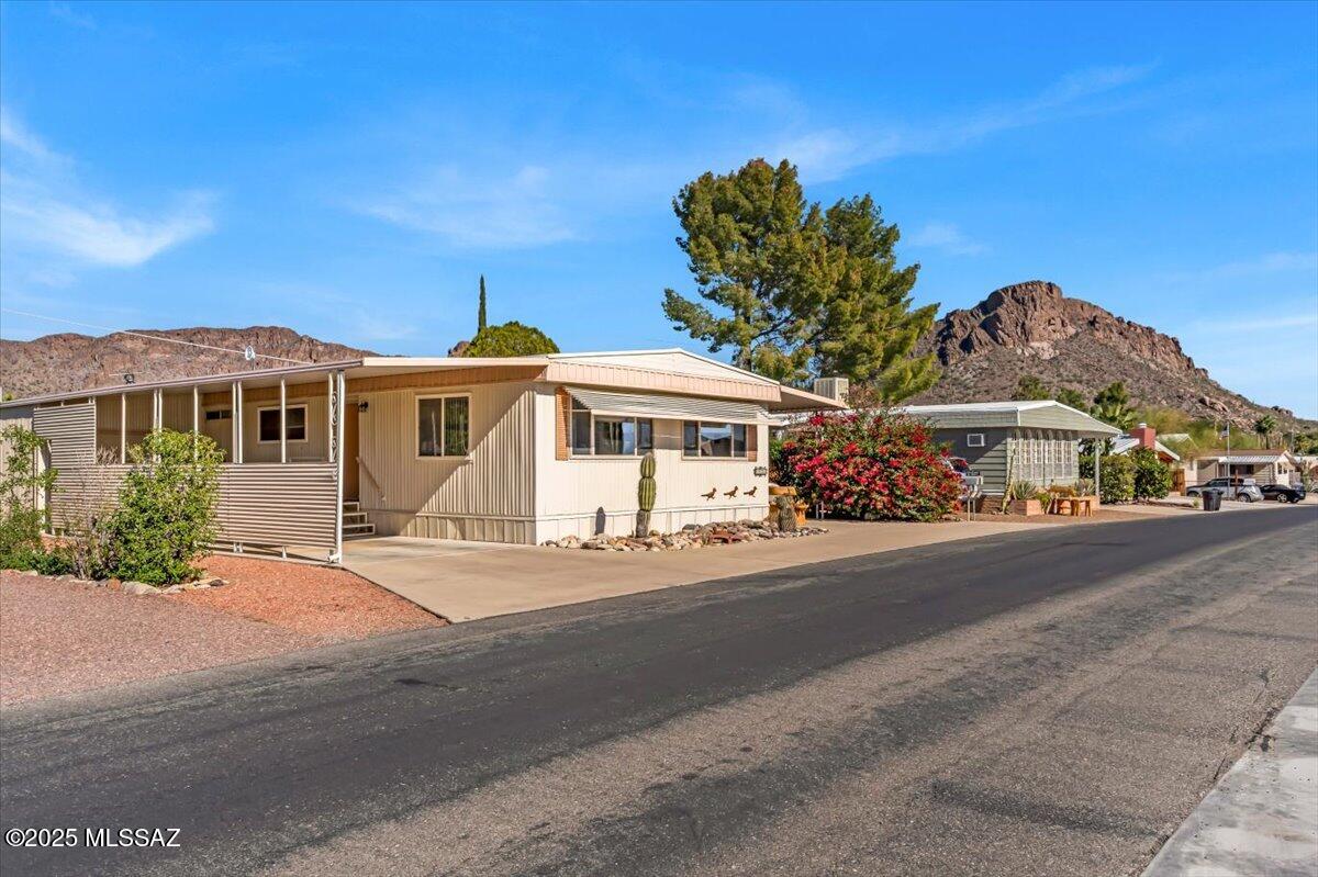 Updated retreat in Tucson Estates! Including dual-pane windows, drywalled interior, 200amp elec. New cupboards in kitchen. Relaxation awaits in the primary suite, which features a large bedroom with walk-in closets and primary bath with dual sinks and a deep soaking shower/tub combo. Drywalled AZ room with newer windows to enjoy stunning mountain views, or soak up the Arizona sunshine from your private patio, GF, Lemon and Orange Trees with picturesque views. Golf cart garage/workshop equipped with power and golf cart, making it easy to enjoy the incl. free golf. HOA also incl. 2 pools, Spa, pickleball, Exercise Fac. and more.