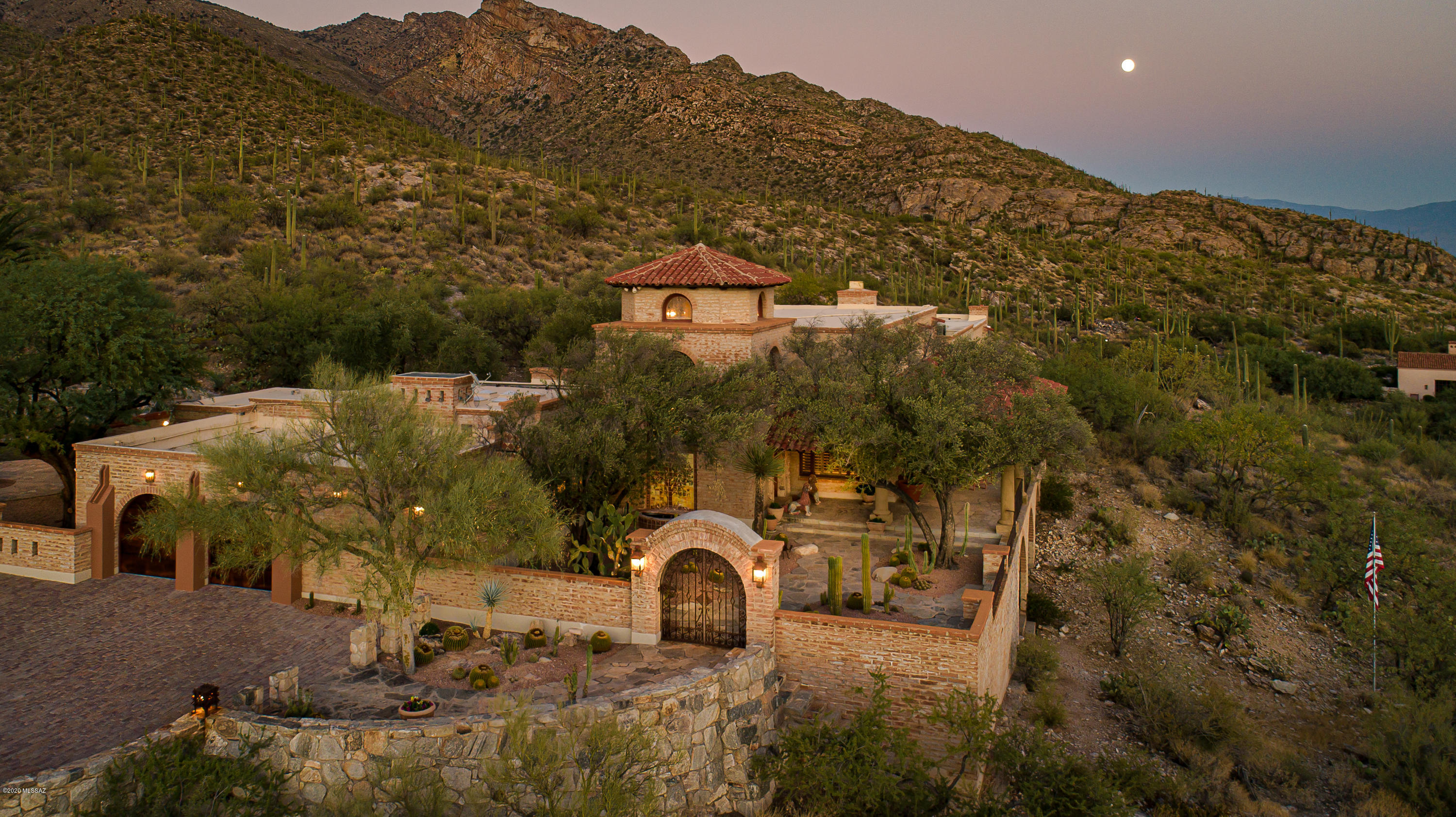 Perched high above the city on one of the best  ridgetop lots in the Foothills sits this magnificent sprawling estate on 7.3ac in ''The Canyons'' & borders the Coronado Natl Forest for ultimate privacy, social distancing & outdoor enjoyment. This convenient central Foothills location is only min away from the best medical care in So. AZ, The UofA, the finest restaurants & La Encatada. Designed by Lewis Hall for the Diamond Family, this impressive estate was built for comfortable yet luxurious living & was geared towards creating an unforgettable resort like experience for your favorite family & special friends. Grand in size and lavish in its amenities, its timeless ambiance & appeal creates a warm and inviting home that truly captures the true essence of Tucson. The main residence features 2 luxurious bedroom suites; one with a fireplace & reading nook opening onto a private patio w/spa & unobstructed views of Finger Rock, two large walk in closets & a master bathroom featuring imported hand painted tiles, a Jacuzzi tub & steam shower. The private office and adjoining library overlooks the grand living room with solid hardwood floors, fireplace, beamed ceilings, walls of windows and offers dramatic city & mountain views. The stunning open kitchen is any chef or caterer's dream w/mesquite cabinets, Wolf & Sub Zero appliances, walk in silver closet & pantry, large center island w/raised serving area, a hand painted mural by Andrew Rush & a well-equipped butler's pantry. For ease of entertaining, there are 2 full size bars, one on each level, a walk in temp controlled wine cellar and a media/rec room (could be converted to a bedroom). Step out to the expansive front patio and gorgeous courtyard to experience jaw dropping city views. The back patio features a resort like pool and grotto designed to incorporate the native boulders and desert environment while reflecting the majestic Catalina Mountains. The adjacent pool house has 2 changing rooms, 1 bathroom, sauna & lower level exercise room. Guests will never want to leave the 2,589 sq.ft guest house with 3 spacious bedroom suites, a full kitchen, 3 fireplaces, Saltillo floors, beamed ceilings and private patios overlooking the twinkling city lights & magnificent mountain vistas. This is a once in a lifetime opportunity to own such a landmark estate in the heart of the Foothills.