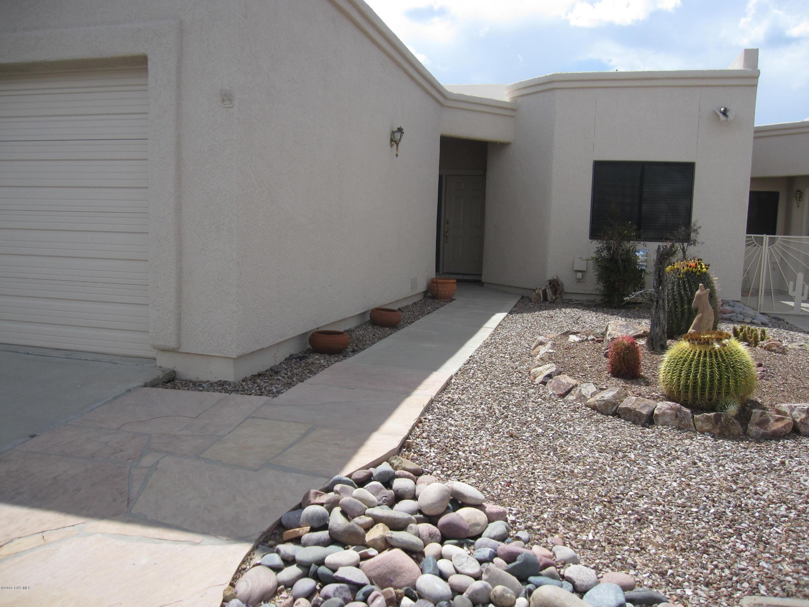 SPACIOUS AND GRACIOUS! LIGHT-FILLED GREATROOM WITH CLERESTORY WINDOWS. PLENTY OF OPEN SPACE. LOTS OF ARCHES AND HIGHER CEILINGS MAKE THIS END-UNIT TOWNHOME A TREASURE! EAT-IN KITCHEN WITH LARGE PANTRY. SPLIT BEDROOM PLAN WITH LOADS OF PRIVACY FOR THOSE UNEXPECTED GUESTS. MASTER BATHROOM HAS DUAL SINKS AND A SEPARATE SHOWER. SPACIOUS WALK-IN CLOSET. LOTS OF STORAGE IN EXTENDED 2-CAR GARAGE. WRAP-AROUND COVERED PATIO WITH LOTS OF PRIVACY! THIS HOME HAS BEEN MAINBTAINED BEAUTIFULLY. NEWER HEATING/COOLING UNIT. REVERSE OSMOSIS. ROOF COATED IN 2015. ONLY ONE ENTRY INTO AND OUT OF THIS NICELY DESIGNED DORN SUBDIVISION. MADERA VISTA TOWNHOMES OWNERS ASSOCIATION PAINTS YOUR HOME ON THE OUTSIDE EVERY FEW YEARS...COST COMES FROM REASONABLE YEARLY DUES OF $475.00.TRINITY ROOF WARRANTY.