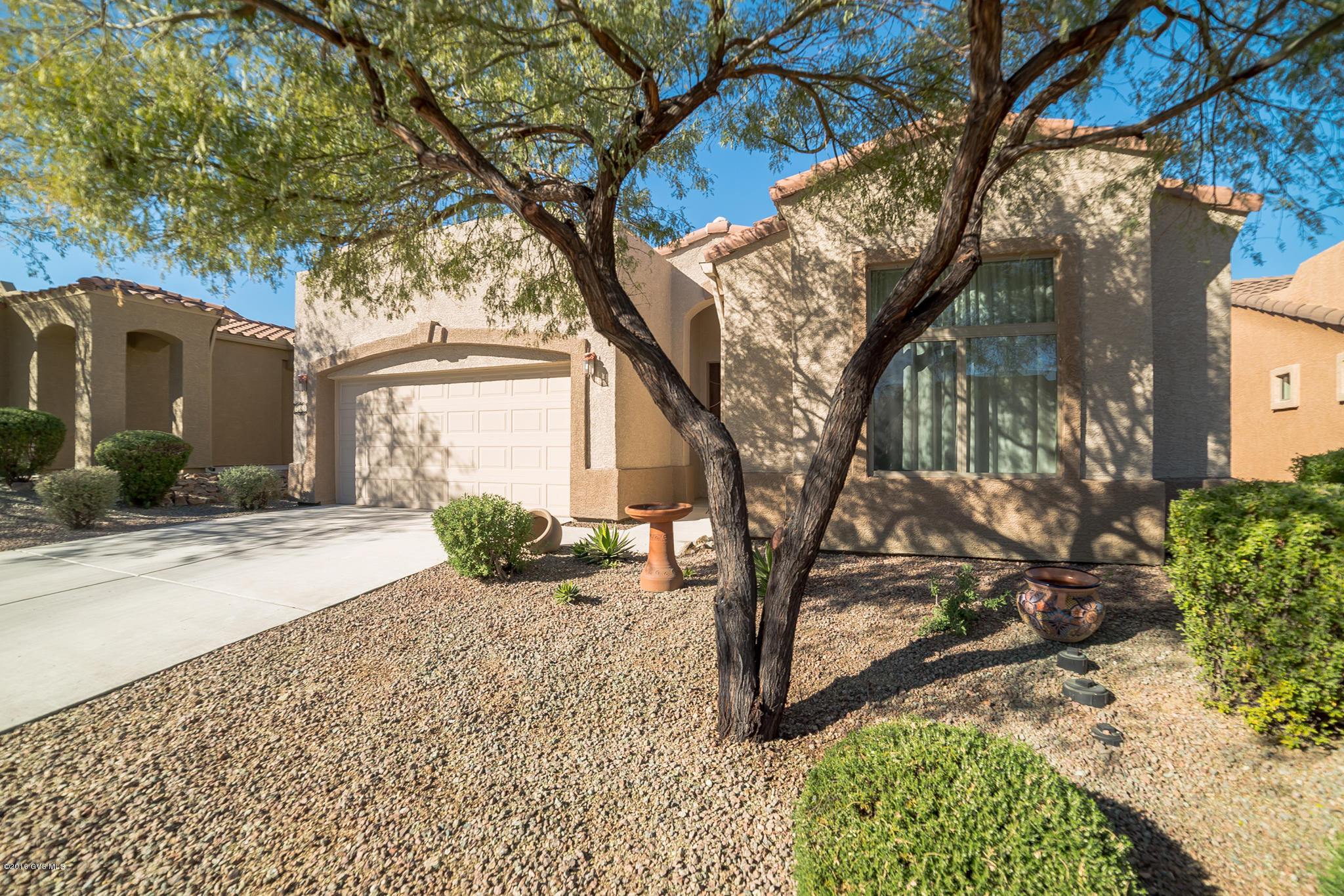 If you are looking for simple, carefree living this is the house for you. The HOA fees provide extended cable TV service, landscaping, structure insurance, road maintenance, exterior building painting, pest control, roof care and garbage pick-up. Nice curb appeal with a mature mesquite tree and desert plantings. Enter into a wide foyer with oversized tile flooring that leads to a spacious great room with contemporary colors and designer window coverings. The open dining area has an opening picture window for light and fresh air. The kitchen features a center island and serving bar, custom pendant lighting and contrasting appliances. A split bedroom arrangement will give privacy to your guests. You will love the large pantry closet. An extended covered patio overlooking a low  maintenance backyard is designed to offer a place to relax. It gets even better - this house is available total turn-key if you'd like!