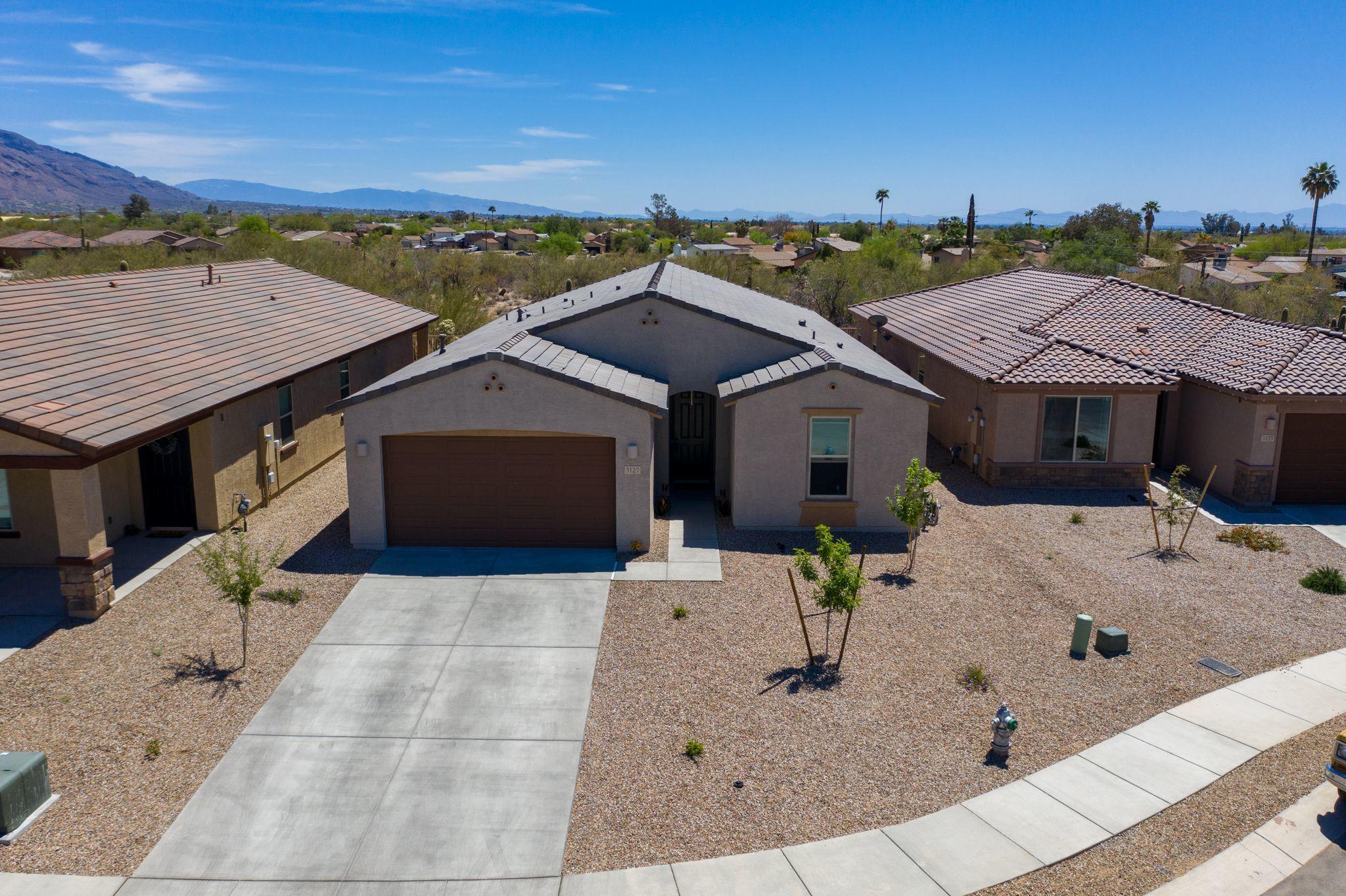 Energy-efficient move in ready HOME! Single story home in quiet cul-de-sac with mountain views. This home features an amazing open floor flan with a large kitchen island, white quartz countertops and a gourmet kitchen with two-tone cabinetry. Large Master Suite with generous Walk-In Closet and bath. 3 Bedrooms, 2.5 Baths, and a den with extra closet. Spacious Laundry room: pre-plumbed for sink. Beautiful tile throughout home except for bedrooms. Extended 2 car garage, outdoor entertainment speakers and TV set up.This home features all the upgrades possible- you don't want to miss out! Close to plenty of groceries stores, Tucson Premium Outlets, Restaurants, fun and entertainment.