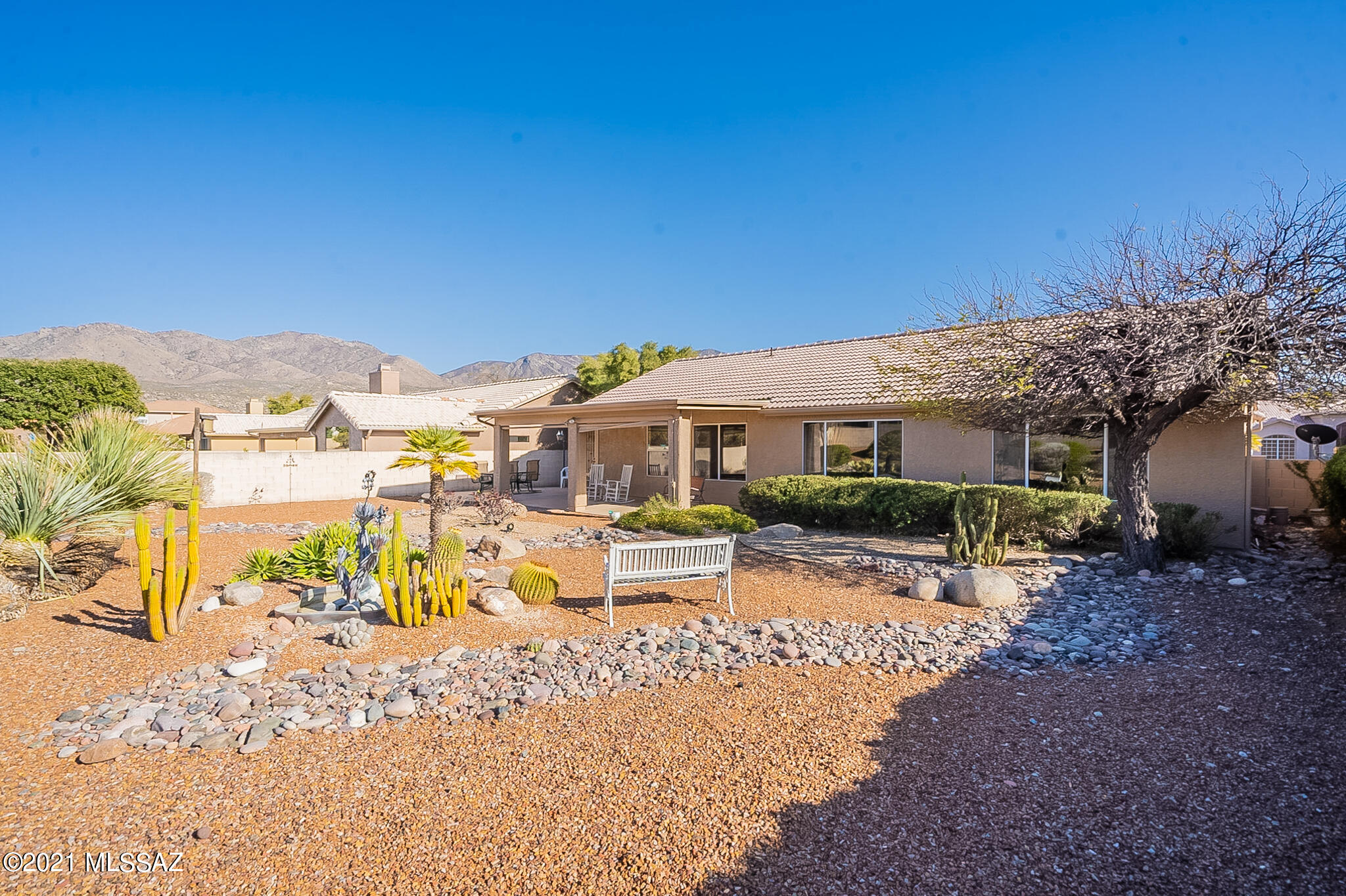 Single-owner Topaz floor plan in friendly Unit 11 between Spoon and Brassie. Large owner's suite with shower, double vanity and large walk in closet. Guest bedroom with mountain view out front. Living and family rooms face back of home to beautifully landscaped low maintenance enclosed lot with room for a pool. Front of home is perfect for patio with mountain view. Kitchen updated with granite counters & backsplash, painted cabinets, and undermount split sink. Appliances as is. Furnace & AC replaced in 2010. Interior and exterior painted with warm designer palette. Tile throughout all except carpet in living room. Come enjoy all SaddleBrooke has to offer!