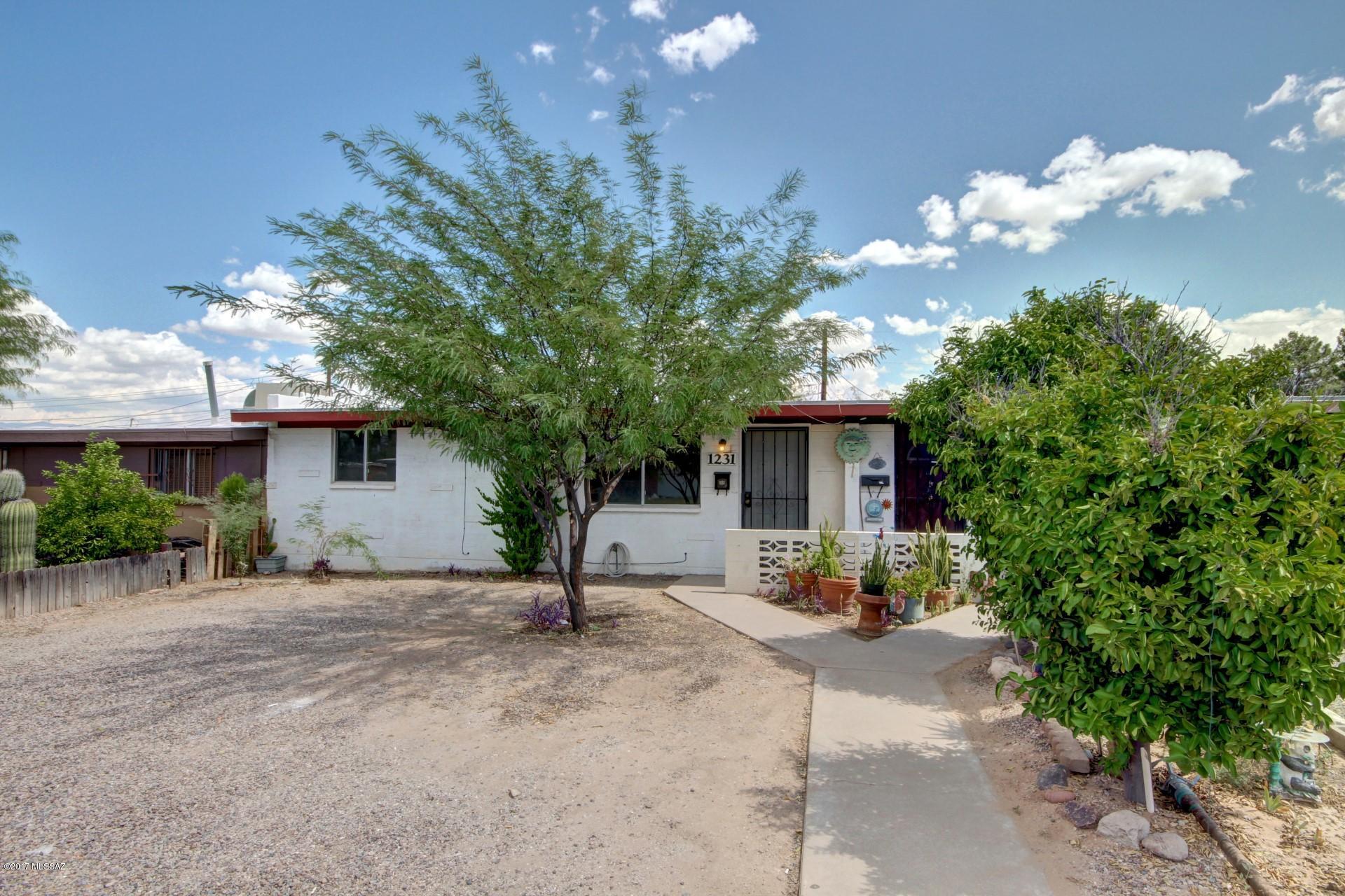 Charming 1960's Ranch Style Home with crisp interior palette, ceiling fans, beautiful hardwood floors, and lots of natural light throughout. Spacious eat-in kitchen features white appliances, wood cabinets with hardware, and patio access. Plush carpet in all bedrooms, ample closets, and interior laundry room with storage. Enjoy the backyard covered patio. Will NOT disappoint! Seller is a licensed AZ real estate agent.