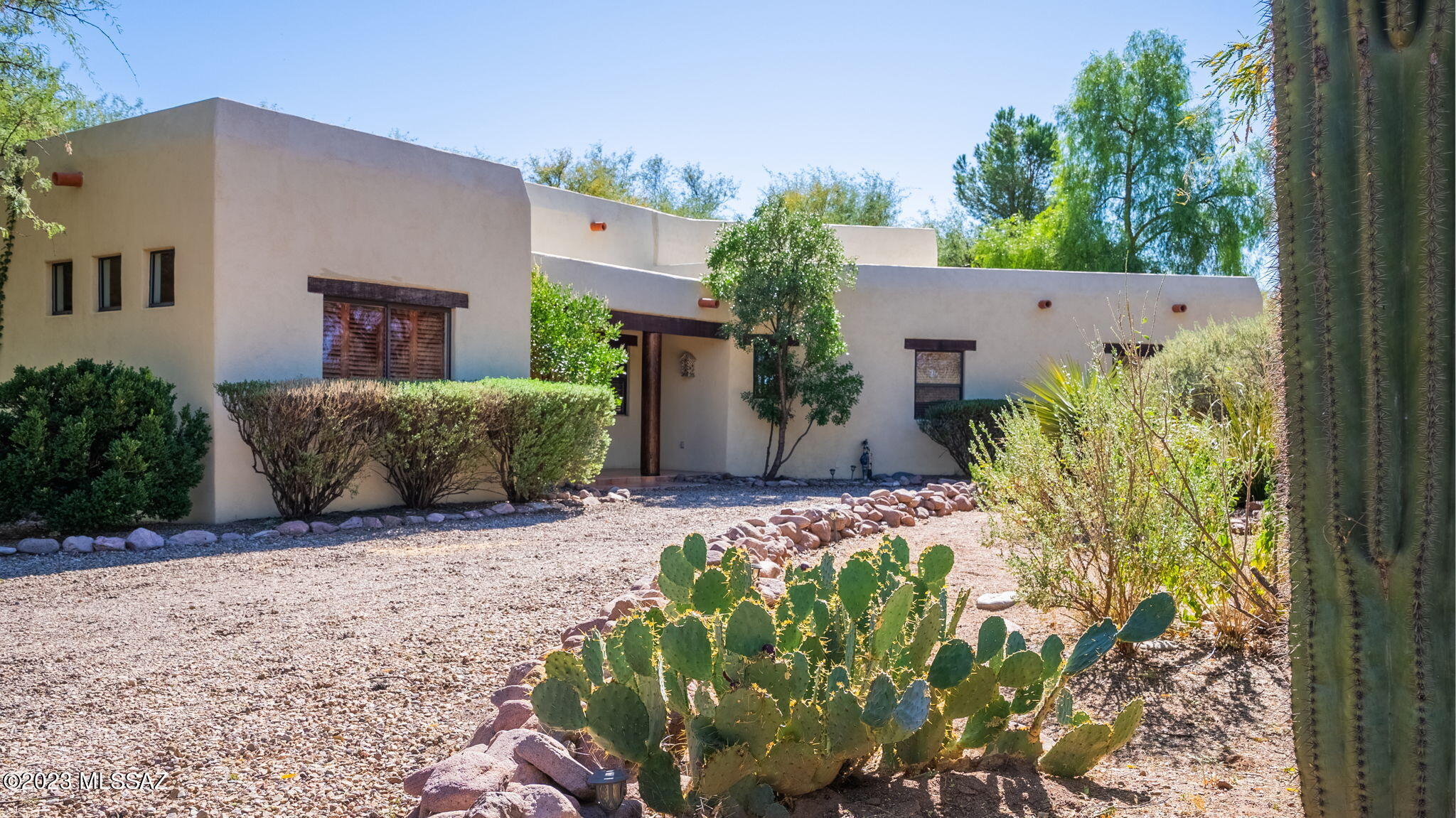 This home has two things everyone wants in the desert; shade and water!!  Beautifully landscaped and maintained home in the Tubac Country Club Estates. With over 2000 square feet of living space featuring 3 bedrooms and 2 baths, amenities also include wood beamed ceilings as well as a wood burning fireplace. In addition to having over an acre of land to provide a privacy buffer,  the backyard oasis is spectacular creating a shaded and private sanctuary you can enjoy all year long. Bordering a common area, this property is both unique and private!  In addition, the property has its own WELL!! It can be switched over to the water company that serves the area at any time!  This is a beautifully appointed home where you can create your best life in Tubac!