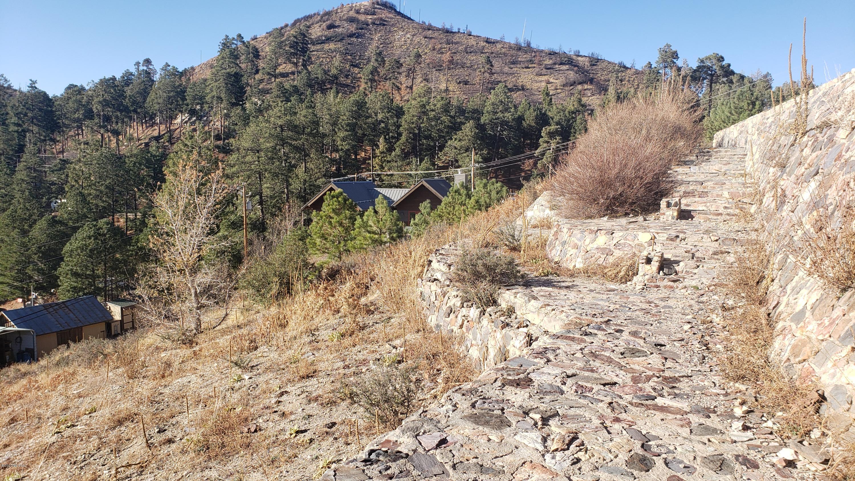 Beautiful terraced lot overlooking the center of Summerhaven Village and Sabino Canyon Valley. Our lot is within walking distance to the village. Sawmill Restaurant is just within minutes on foot. Extensive rock work retaining walls, patios and stairs. Watch all the activities in town from your own balcony on this lot. Access from above and below. Septic is installed on this lot. 3 lots total available (11318 E Bisbee Ave, 11320 E Bisbee Ave. and 11322 E Bisbee Ave). Purchase all 3 for $114,000.