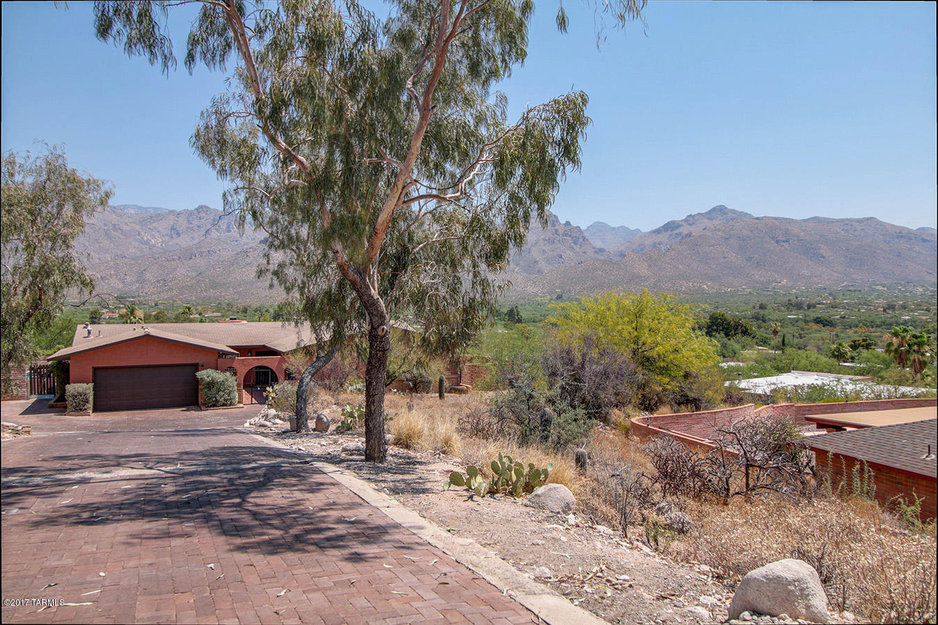 Breathtaking Panoramic Views!4br/2ba/2car garage Spanish Style retreat overlooking the Catalinas!Saltillo tile throughout main living area.Kitchen has granite counters,gorgeous,cabinets,backsplash,and views!Huge family room with French doors that open to courtyard.Living room has wood burning fireplace.All bedrooms are large and have ceiling fans.Master bedroom is huge w/walkin closet and Spanish style bathroom.Backyard oasis with sparkling pool, outdoor grilling area, and views!Must See!!