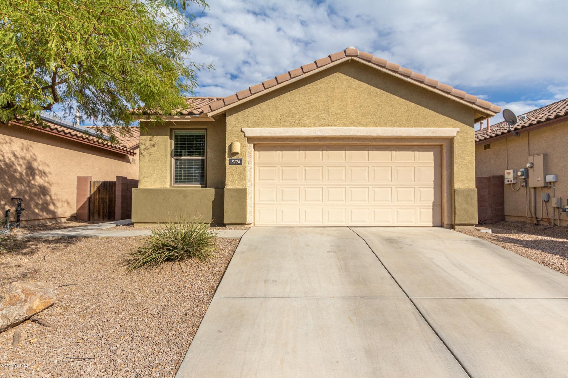Gorgeous ''Model'' perfect single story home in the desirable Community of  Paseo Del Rio. Dramatic foyer entry w/a decorative  medallion in the tile floor, welcoming paint palette, private den, plush carpet, ceiling fans, window blinds, & beautiful tiled floors in all the right places. Stunning chef's kitchen features granite counters, breakfast bar, updated Whirlpool appliances, pantry, & handsome 42 in Cherry Wood cabinets w/crown molding & travertine backsplash.  Engineered wood floors in 2 bedrooms, ample closets, 2 pristine baths, with new quartz countertops & Kohler undermount sinks. Laundry w/Updated washer and dryer.  The master retreat boasts a large walk-in closet, plush carpet, & dual sinks in private en suite.New light fixtures through out, custom wrought iron security doors front and back doors, and new decorative landscape rock in back yard. Walking distance to grocery, schools and the beautiful Rillito River Walk and Bike Path.