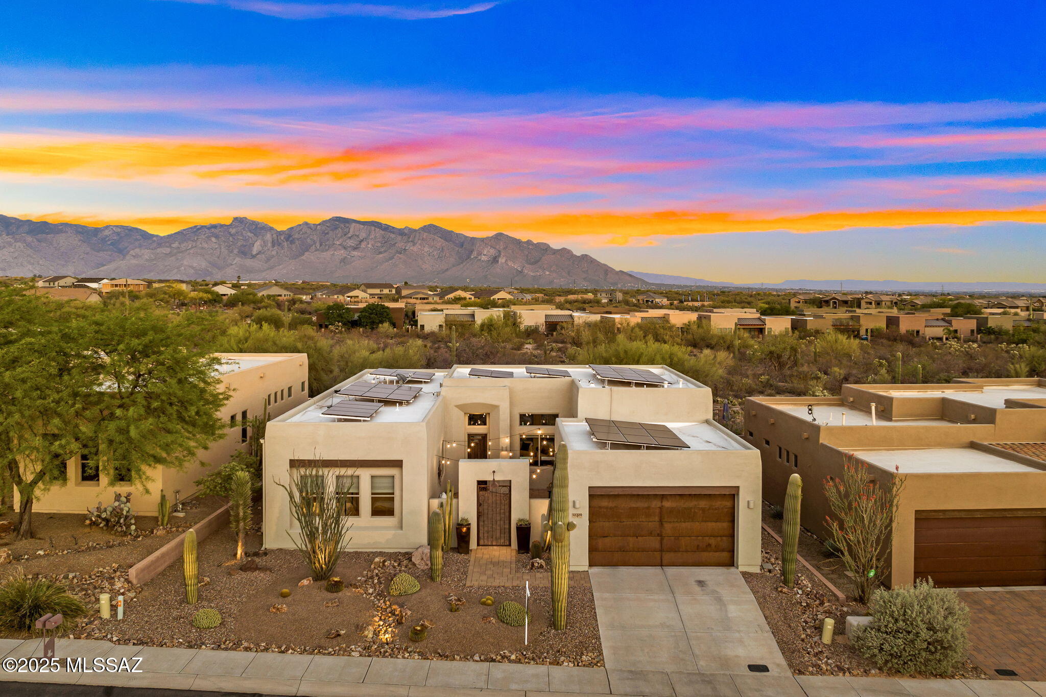 Tucked away in the gated community The Preserve at Dove Mountain, 12320 N Sunrise Shadow Drive offers gracious desert living in an energy efficient solar powered home. Sitting on an elevated Eastern facing lot with designated open space behind, the property offers unobstructed Catalina Mountain views. Built by a local custom builder Insight Homes, the Santa Fe style architecture is blended with modern elements creating a clean, yet comfortable setting. Substantial in size, the front courtyard is finished with pavers, functioning as another room of the home. Inside, a sense of airiness is felt from 12-foot-high ceilings, oversized windows and generous spaces. The 2,417 sq ft layout includes 3 bedrooms and 3 full baths, with an extension on the front of the home, effectively creating dual primary suites. Large format tile spans the great room and chef's kitchen, which includes granite counters and GE Monogram appliances. A separate bar area includes a beverage refrigerator, providing effortless flow for entertaining.

Improvements made over the last several years are abundant, high end, and include: a fully owned TESLA solar system with 3 power walls, new 80 gallon electric hot water heater, 2 new HVAC units, a whole house humidification system, roof recoating with a 10 year product, new exterior paint, new pool equipment, gutters, and a Lutron lighting system. The home also includes a Sonos sound system with speakers throughout.

Completely finished with a pebble tec saltwater pool, in ground spa, and gas fire pit, the backyard is a lovely space to enjoy, yet easy to care for. With a designated nature preserve behind the lot, the desert and mountain views will remain as they are today.

Lifestyle and convenience from this location are dynamic. It's easy to walk, run or cycle from your front door with neighborhood sidewalks, a trail system and multi-use paved path all immediately accessible. Within Dove Mountain, there are 3 golf clubs, the Tortolita Preserve with 10 miles of singletrack, and the Wild Burro trailhead with peaceful and varied hiking trails. Within 2 miles, there are plazas with grocery, dining, pharmacy, urgent care, veterinary, banking, and other services. From this location, interstate access is quick and easy, making travel to Downtown Tucson, the Tucson Airport, or the Phoenix metro area simple.