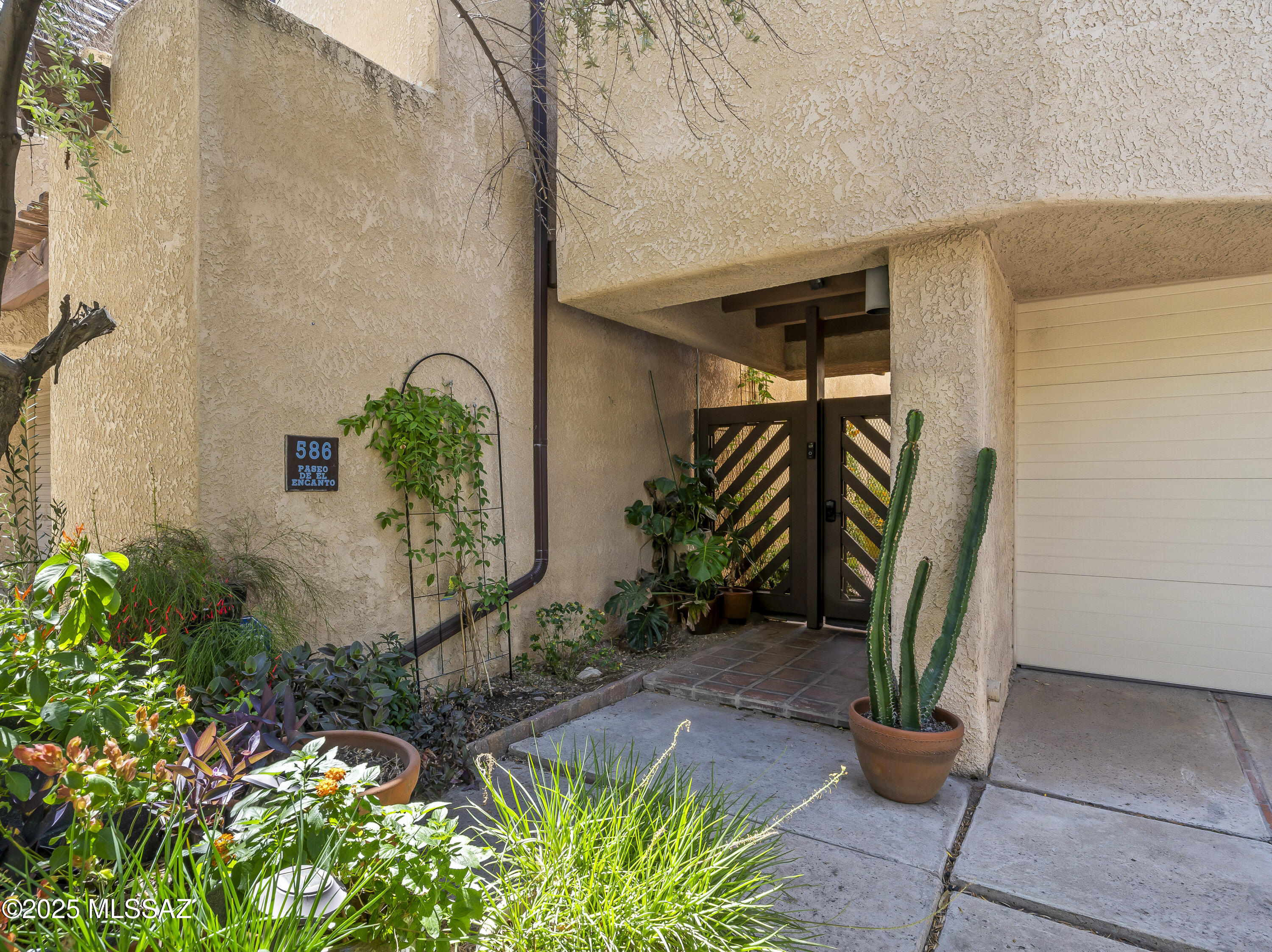 Rare Opportunity in Paseo De El Encanto!

 Townhomes in this coveted community seldom come to market—don't miss your chance to own this one-of-a-kind desert retreat in the heart of Tucson. From the moment you enter the private courtyard, you'll be swept away by the home's whimsical charm and serene ambiance. Tall perimeter walls and a gated entrance offer a peaceful, secluded feel, all just one mile to the University, restaurants, and shopping. Inside, the home is filled with character: soaring ceilings, open living spaces, polished concrete floors, custom light fixtures, and a beautifully updated modern kitchen. Every bedroom has its own bathroom, and nearly every room opens to a patio. The oversized primary suite features a walk-in closet, dual showers, fireplace, open loft style layout, and direct access to the outdoors. There's also a bonus second primary suitecompletely privatewith its own patio, perfect for guests or a serene home office.

Love being outside? You'll adore the five separate patios throughout the home, each offering its own unique vibe. Sip your morning coffee on the sunny terrace between the two primaries, unwind on the poolside patio at sunset, or tend to your potted garden in the lush courtyard surrounded by blooming flowers, butterflies, and hummingbirds. (Select plants may stay for buyers who share a green thumb!)

This home is the ultimate blend of privacy, character, and location. Schedule your private showing todayhomes like this don't come around often.