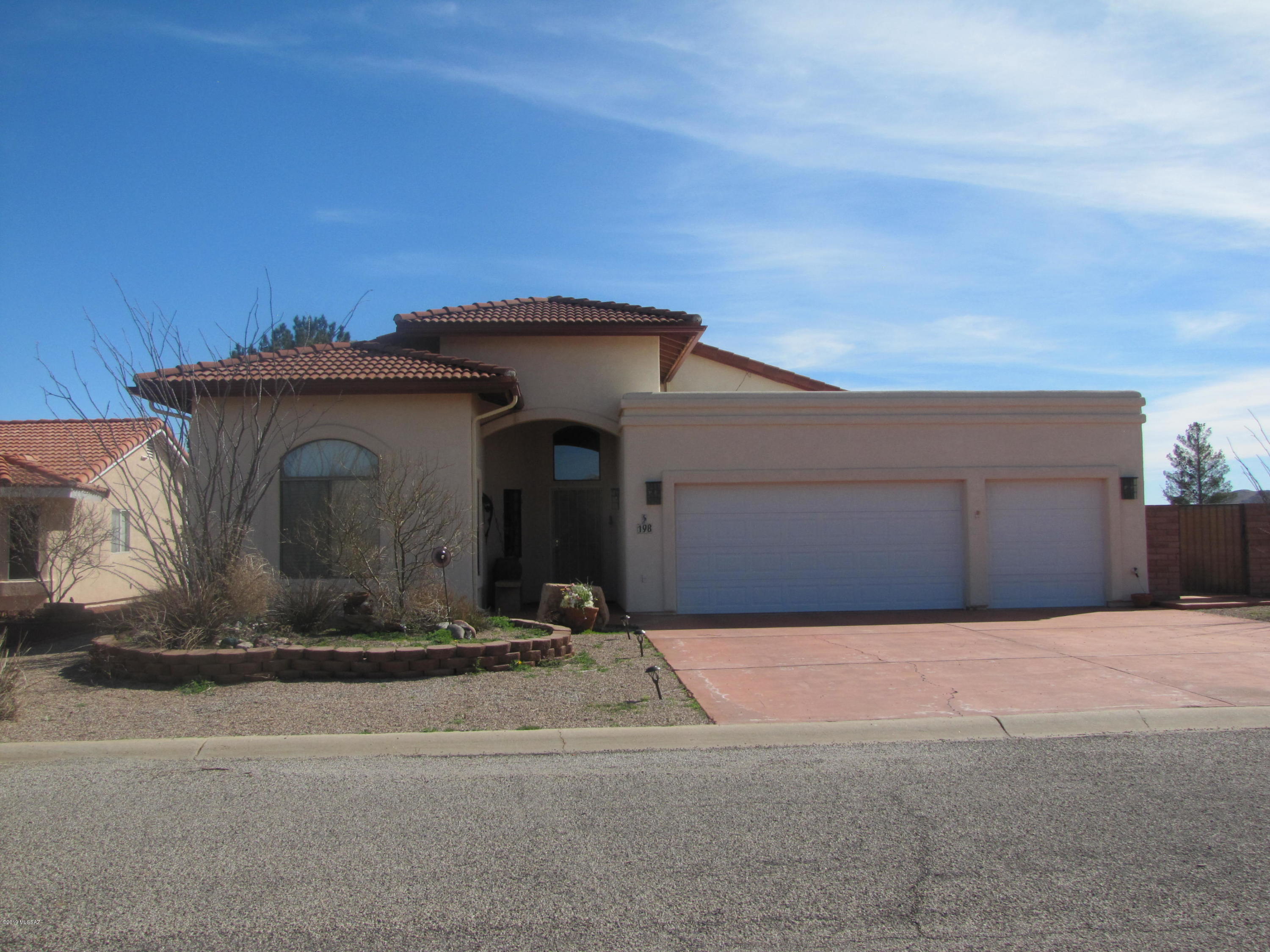 Beautiful 3BR/2Ba home with in-ground saltwater pool and great view of Cochise Stronghold. Roomy entryway with guest BRs and Ba as enter house. MBR suite has sliding door onto back patio + French doors to atrium for your morning coffee. MBa has dual vanity and walk-in closet. Laundry room off foyer into MBR then into garage, with separate overhead doors for cars + smaller car or golf cart. Vaulted ceiling in LR with plant shelves & window overlooking backyard and pool. Sunny open floor plan for LR, dining area & kitchen  with window over sink. Thru French doors from dining area into AZ which opens onto covered tiled patio and swimming pool. Backyard surrounded by brick wall yet still able to see surrounding mtns. Located in village of Sunsites with amenities + easy access to I-10.