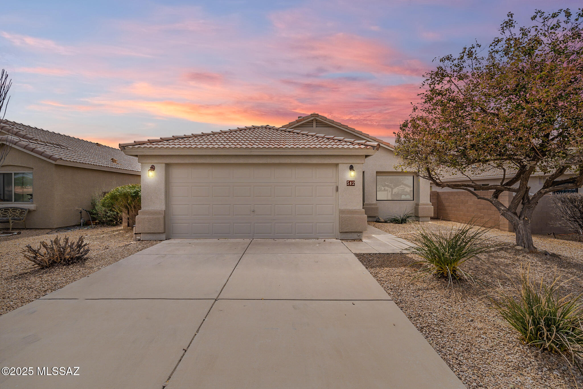 Amazing opportunity for turnkey, updated and upgraded 1,512 SqFt 3bed/2 full bath modern contemporary with attached 539 Sqft extended two car garage, on .14 acre lot in desirable Santa Rita Ranch neighborhood in vaunted Vail School District. Built in 2004, N/S orientation, single story, no stairs/no steps, concrete tile roof, freshly painted 2025, concrete sidewalk, concrete driveway, on and off street parking and low care front landscaping. Step inside to appreciate updated, reimagined home featuring: Energy efficient double pane windows throughout w/window screens, custom blinds, soaring textured painted ceilings (no popcorn), 7'' wide Luxury Vinyl Plank flooring (no carpet) with upgraded pad, 5 ¼'' white baseboards, LED recessed lighting, Pex plumbing, water softener (new 2024), reverse osmosis (new 2024), new gas HVAC Oct 2021 ($7300), NEST digital thermostat, wired for alarm, modern light fixtures, oil rubbed bronze hardware & door handles, ceiling fans, solar tube, internal laundry room with LG washer & dryer on pedestals included, updated "assist" toilets, updated full guest bathroom with quartz countertop with updated vanity and attic storage access. Enjoy both a formal living and a spacious family room, with adjacent dining area surrounding open concept kitchen boasting full slab granite counter tops, bar seating, stainless steel appliance package, gas stove, upgraded 42" café maple kitchen cabinets, new dishwasher, weathered barn board wood plank decorative paneling, large metal under mount sink and garage disposal. Spacious family room includes surround sound speakers, wired for surround with double pane slider out to covered patio. 
Primary bedroom includes updated ensuite full bathroom with full slab granite countertop, dual sink modern vanity, crisp white backsplash, massive soaking tub (new 2021), black hardware and walk in closet. Large attached 539 SqFt post tension two car garage with 5' extension has copper plumbed water softener, epoxy shielded concrete floor and convenient side door access to finished backyard. Enjoy tranquil sunsets from extended covered patio with low maintenance backyard including always green artificial grass, irrigation on timer, gate access, surrounded by concrete block privacy walls. 
Low $34 monthly HOA dues include Santa Rita Ranch community park. Only .6 mile from both Sycamore Elementary and Corona Foothills Middle School, short distance to Corona De Tucson, Davis-Monthan Airforce Base, Raytheon and HWY 1-10 access. This updated home is ready for new owners to enjoy, call to make your appointment to view this beautiful move in ready home today!