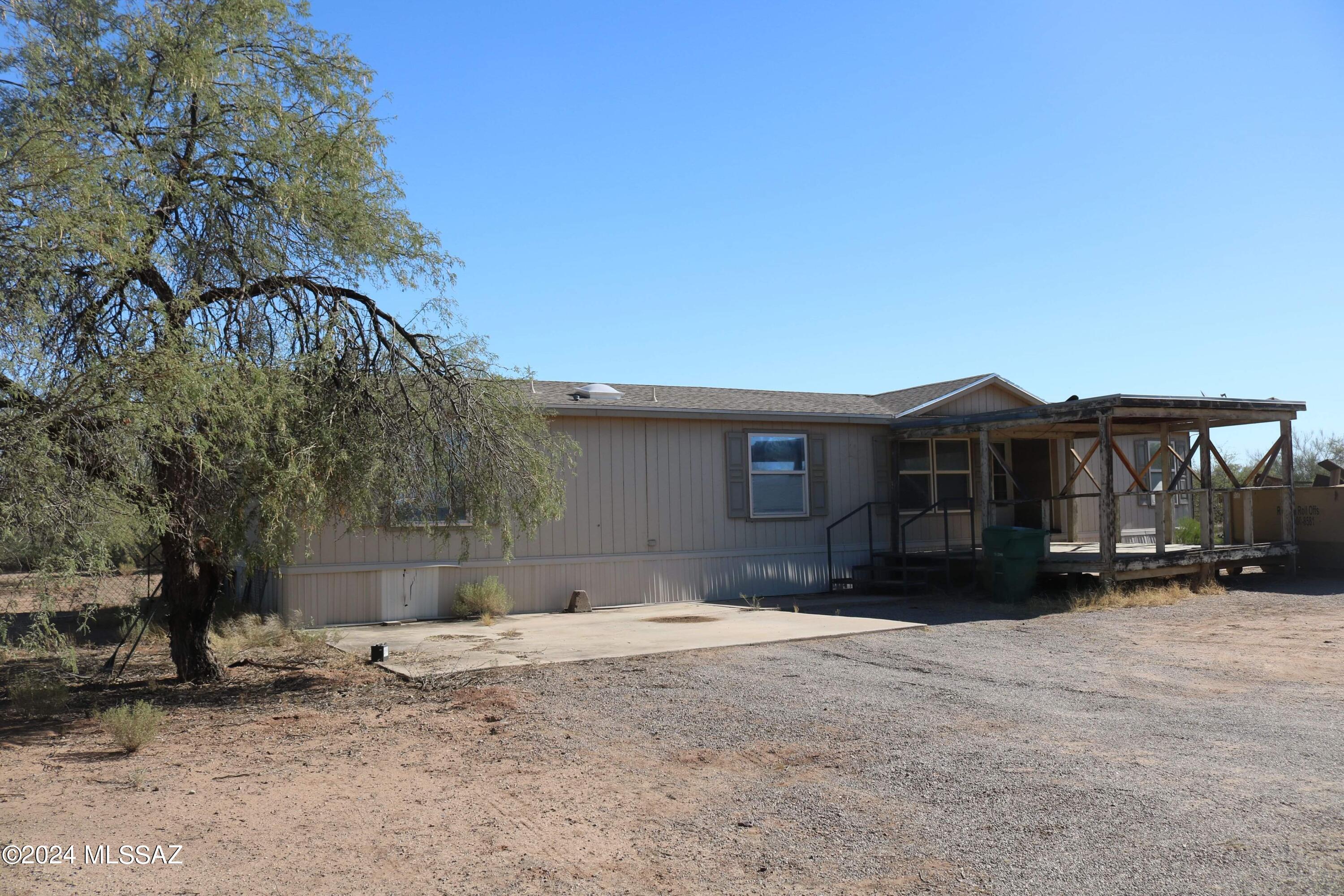 Perfect gem in heart of Avra Valley Marana! 3 bedroom 2 full bath 2001 manufactured home on just over an acre! Close to school and major shopping! Tucson Premium Outlets are within minutes from this home! City water, paved road all on horse property!  Come take a look and make that dream of yours  come true for you and your family before the holidays! This is and ''AS IS WHERE IS'' sale, but is habitable and all appliances work! Seller will not do any repairs or improvements. CASH, CONVENTIONAL,  SEE IT TODAY! PRICED TO MOVE FAST!