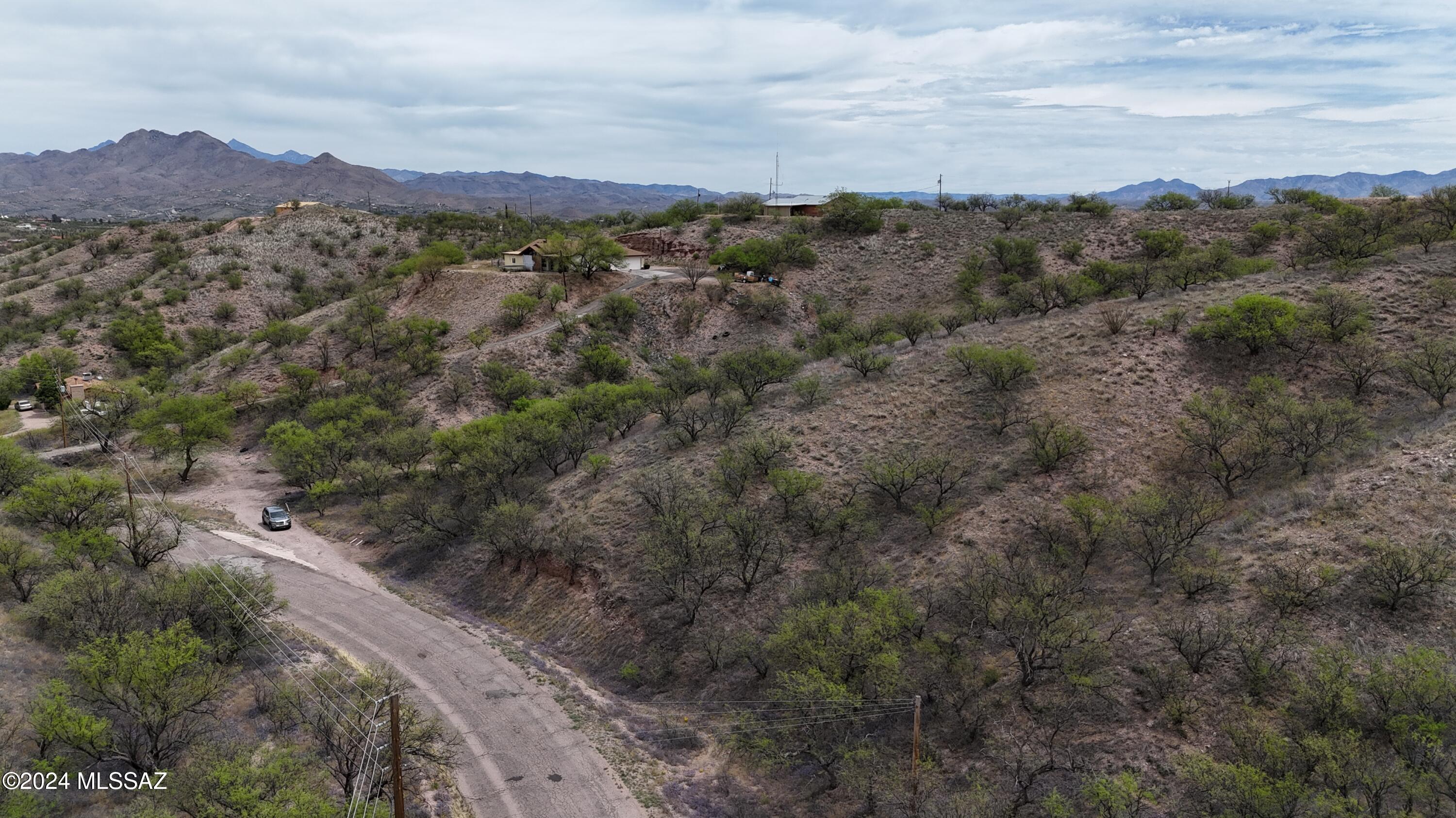 This lot and the one next to it are being sold by the same owner.  977 and 979 Calle Amarillo.  The lots have hills on them which will require grading to put in a driveway and create the building pad.  These lots are only a few miles from the heart of Rio Rico at the Rio Rico Drive exit from I-19.