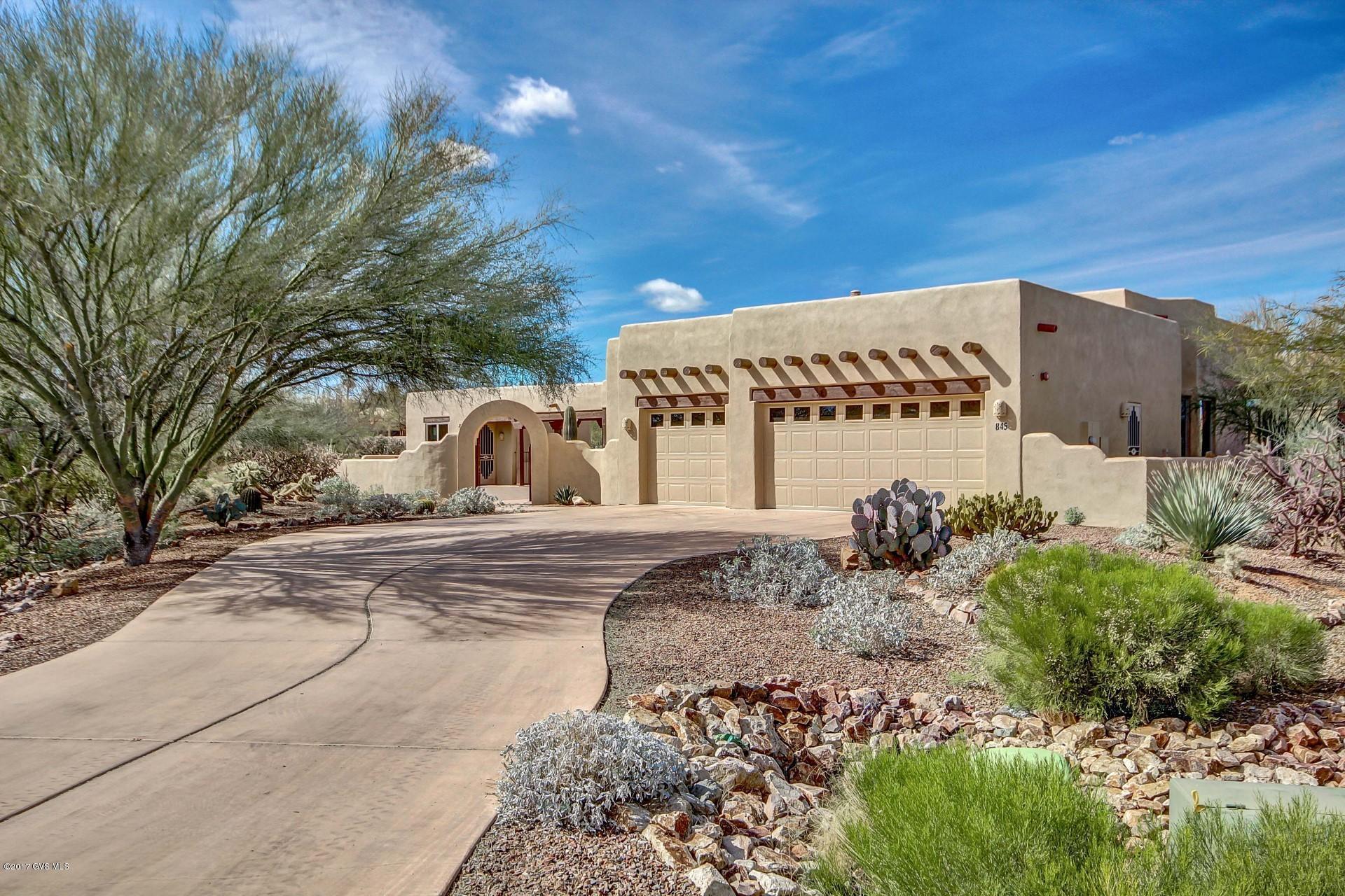 Beautifully appointed Santa Fe style Dorn Home with casita, solar heated pool on a large lot with front gated entry into courtyard.