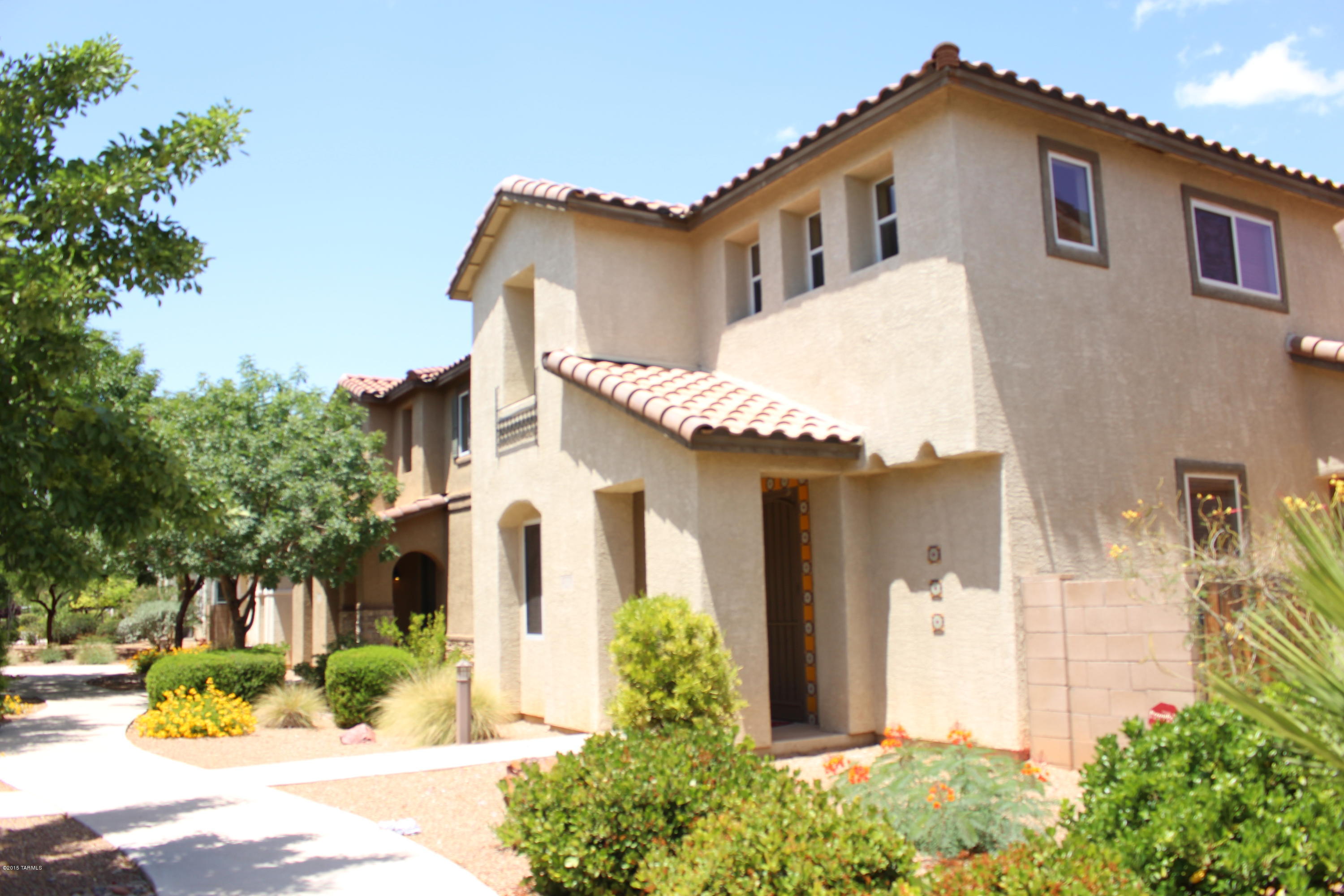 Open Modern Floor plan with wall to wall tile in the great room and kitchen is the focal point of this clean four bedroom plus loft home in great central location across from Fort Lowell Park and Pool, and just up the street from the Tucson Medical Center. Master Bedroom and 2 additional bedrooms plus loft upstairs and a bedroom and bath downstairs as well! Kitchen has lots of storage and counter space, stainless steel appliances, double sink, flat top stove. Master suite is very spacious, with a huge walk in closet, dual vanities,  separate shower and tub. On the second floor there is a loft area, could be used as family room/ kids area/ office/ TV room. Electric fire place in the living room. Beautiful french doors take you out to the tiled and private patio area.