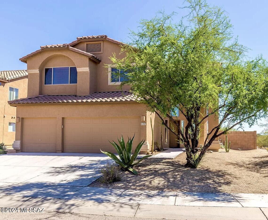 This Corner lot, 4 Bedroom 2 and a half bath home has beautiful mountain views with breathtaking views from the balcony! Home has plenty of upgrades, open rail oak staircase, ceramic tile in kitchen and wet areas, faux wood blinds, Zodiaq quartz composite counters, sitting room/office space next to master bedroom, covered patio & deck off back of house affords awesome views of Tucson Mountains. & natural desert.