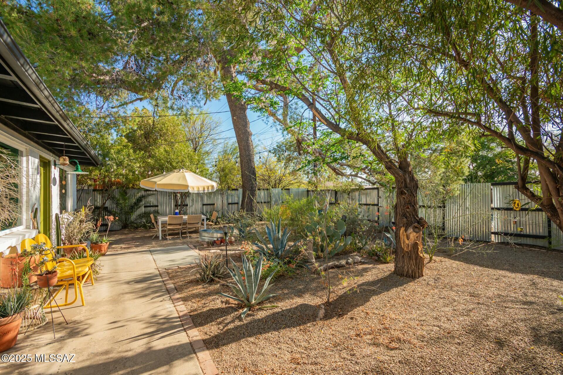 Experience an Urban Oasis with Sustainable Living & Outdoor Charm! Live in the middle of a Bike Lovers Paradise: Bike to The Loop, Quick access to 2 (soon 3!) bike boulevards. Local hotspots include Tucson Hop Shop, Monsoon Chocolate, Hello Bicycle, Clay Co-Op and Tucson Botanical Gardens.  A private, secure, outdoor haven with stunning native, drought-tolerant plants that attract a variety of bird species. Shady & peaceful w/ 2 gorgeous towering pines & zen space. Great neighbors! This home features Original beams, excellent natural light, newer windows, and farm sink.  3.9KW solar system helps lower utility bills. Large backyard/ lot: Room for an ADU and/or outdoor kitchen potential & Catalina views. Enjoy a private sanctuary in the middle of town!