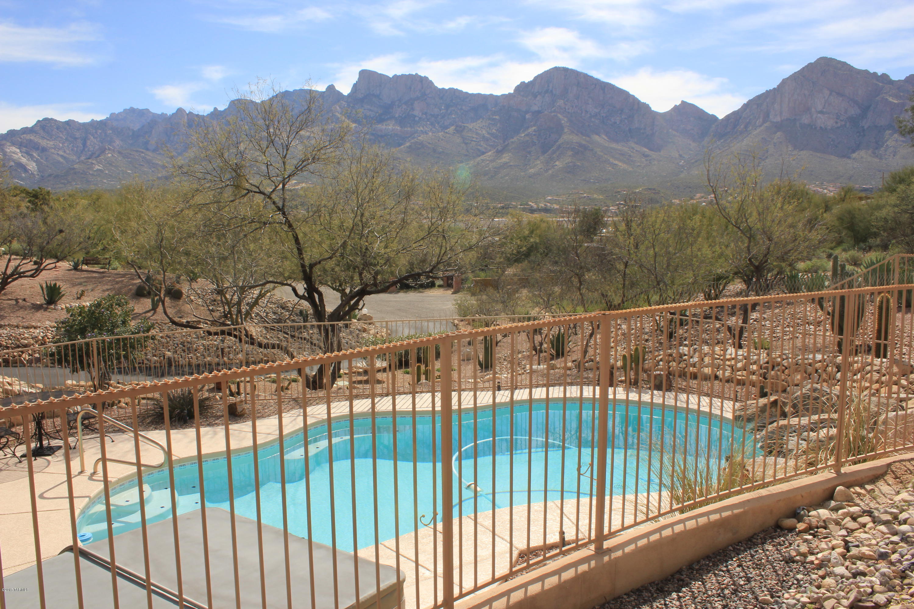 Views Views and More Mountain Views! This lovely custom home is snuggled on a private quiet 1.24 acre fully landscaped lot. This gem has been lovingly maintained and an open floor plan designed to showcase the lovely Mt views from walls of windows, patio and pool. The Great room has lots of niches and a fireplace. The kitchen has slab granite counters, stainless appliances and center island. Family room or office off kitchen. Dine in a spacious area with a wall of built ins. Split Bedroom plan features large master and huge walk-in closet, Bedrooms 2 and 3 with Jack and Jill Bath. Many value added appointments.Enjoy the Lovely Pool and Spa on warm summer nights! This private desert treasure is designed for relaxing and entertaining!Approx 150 sq. ft. more then assessor 2308 sq. ft.