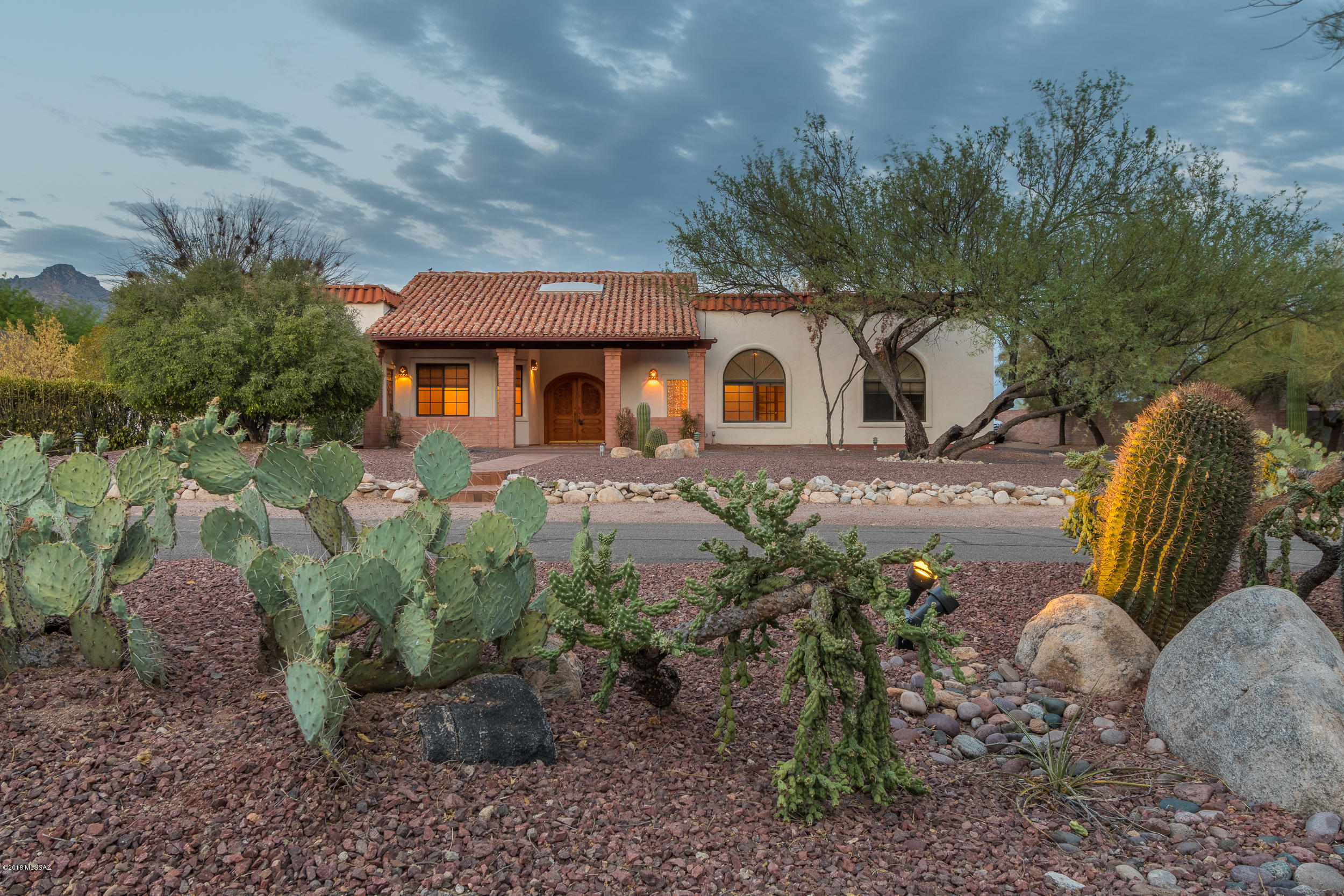 Looking for a home with great bones that you can make your own? Located in one of the best kept secret neighborhoods in the Catalina foothills this open floor-plan 3,020 square feet split bedroom plan has 4 bedrooms plus a den/office & 3 full bathrooms. Great eat in kitchen with breakfast bar that opens to large family room. Home has additional dining area, living room with wet bar and masonry fireplace. Master Suite is great size with large bathroom and walk in closet. Backyard has covered patio,great mountain views and wonderful pool and spa.Laundry room and oversized 2 car garage give plenty of room for storage.  Home is waiting to be re-imagined and priced to sell.