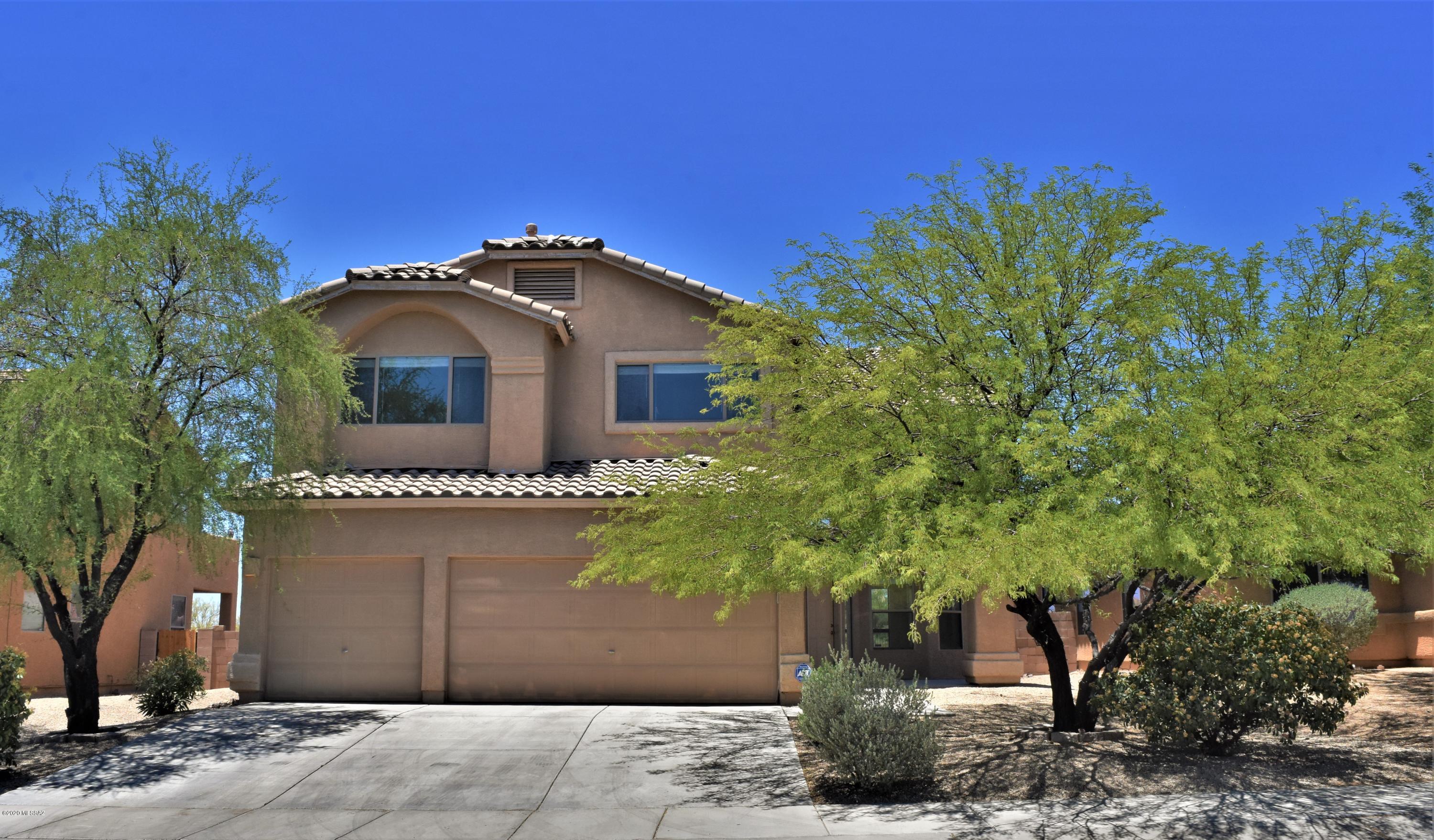Gorgeous home situated in Southwest Tucson. Home features a stunning 3-bedroom floor plan with a loft/bonus room, a 3-car garage, excellent curb appeal and new carpet! Impressive, bright open floor plan with high ceilings and many windows to bring in the natural light. 2 living rooms/gathering areas on the 1st floor. Great open kitchen with a breakfast bar, nook, formal dining, and a great room with a fireplace. Perfect for entertaining. French double doors welcome you into a large master bedroom suite with a walk-in closet and a bonus loft area overlooking the entire first floor. Incredibly sized master bathroom with a separate walk-in shower and garden tub. This move-in ready home has a large and spacious backyard!