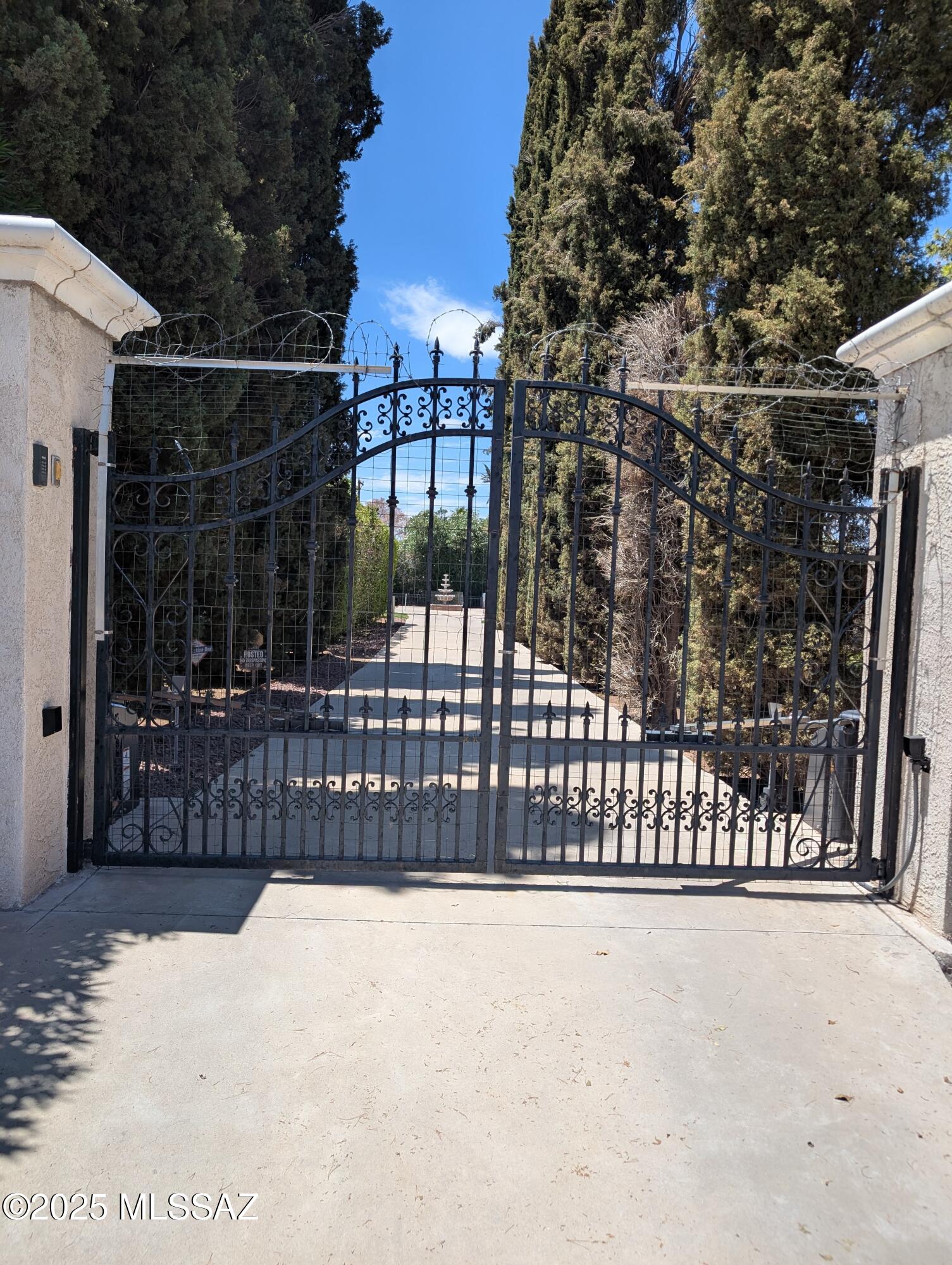 Estate Sale; Exquisite Paradise in Mid-Town, offers beautifully maintained gardens and luscious landscaping w/ breath-taking mountain views, tall palms and bougainvilleas laden with flowers. Mid Century Modern 5/3 bedroom home on 1.78 acres. 2,643 sq ft with 3 sheds, green house, gazebo, Lilly pad pond and 3 fountains. Gated entry w/ Cypress trees lining the driveway to the home. Formal dinning room, Fireplace, TV/family room, split bedrooms Kitchen has pull out shelves, extra storage, fully equipped.  Newer plumbing seller spent $37,000 sewer and water lines. Newer HVAC split unit.  High hedge complete circle the property, security monitor/ fire detection  provide privacy and security.Private non-exempt well on property, Splitable lot, zoned R-2. See also MLS#22519239 for Land/Lot listin
