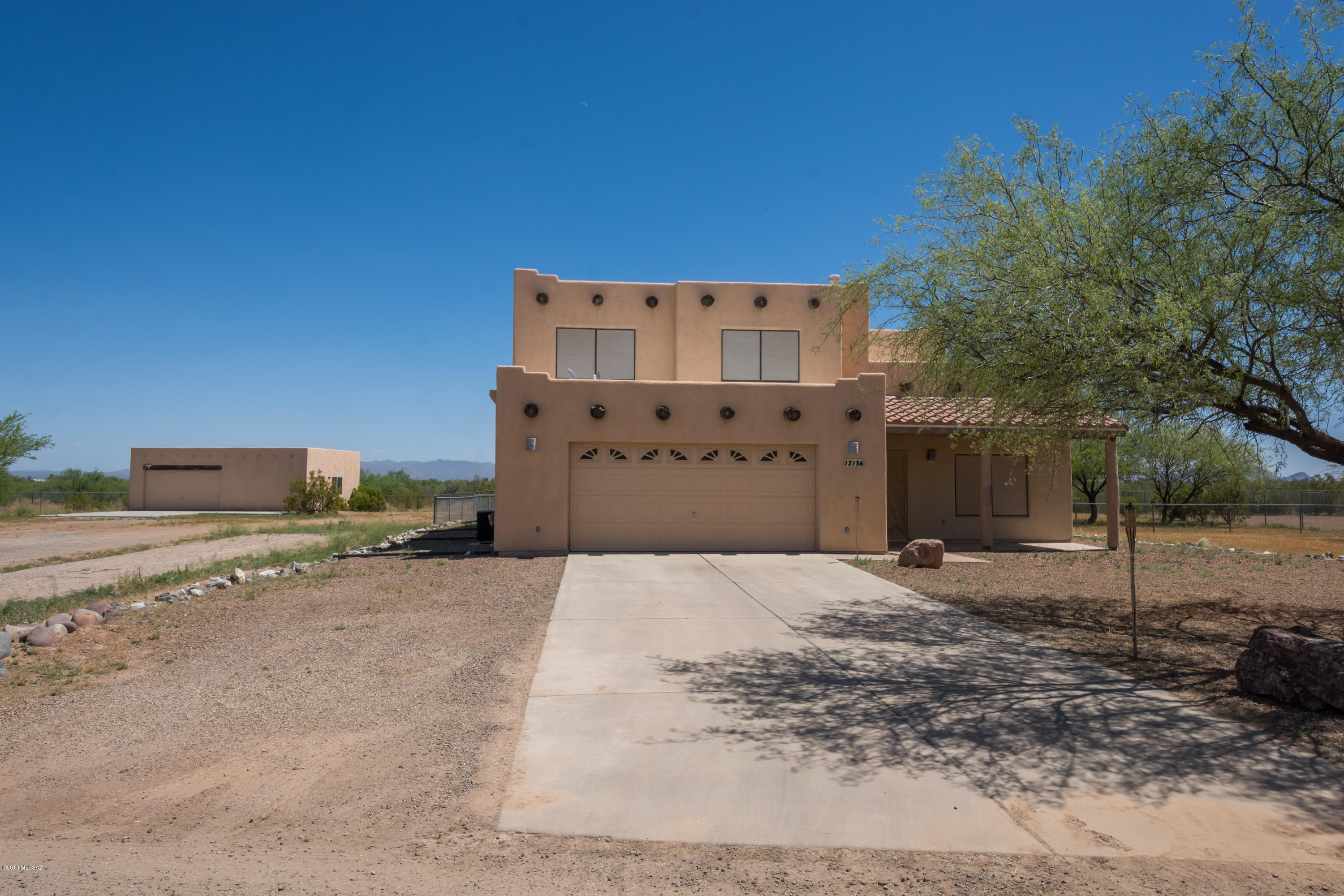 TOO GOOD TO BE TRUE !! This 5 bed/3BA home on almost 1 full AC w/ 4 car garage & Catalina Views ! This property qualifies for USDA financing ! ZERO DOWN !

Formal living room &  dining room  leads to spacious kitchen w/ hickory cabinets thru out & greatroom floorplan. One bedroom & full bath on bottom floor including laundry room w/ utility sink. AZ room has it's own AC & leads to covered patio.  3 BDRMS w/ shower/tub combo & Master w/ Bath on upper level. Stunning Views from master balcony. Master bath offers dual sinks w/ soaking tub & walk in shower & closet. There is 2 car garage attached to the home & a separate 2 car garage w/ workshop across the yard. Perfect for all the toys !  Workshop has a toilet, sink & electric. Solar screens thru-out.   Call for private showing & finance in