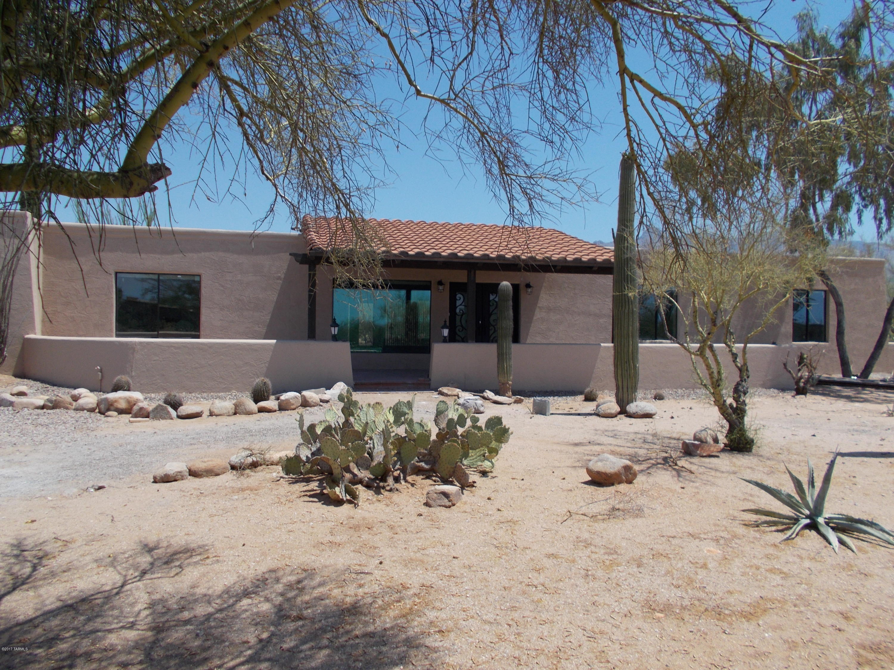 Be the first to enjoy this gorgeously remodeled 4 bedroom 3 bath, 2611 sq ft home with pool. Big Double doors great you as you walk up to the walled covered  front patio and into the enormous great room. Several large windows in the home give it tons of natural light.Wood like tile throughout with carpet in the bedrooms. French doors lead out to the backyard covered patio and pool from both the great room and Master Suit. Granite counter top throughout with kitchen having black tile back splash.Bedroom off kitchen will be great for guest, grandparents or older children.Home has circular drive,is located on almost an acre in the desirable Catalina  Foothills Estate and the Amphitheater School District. With its North facing views you will get to enjoy the beautiful Santa Catalina Mountains.