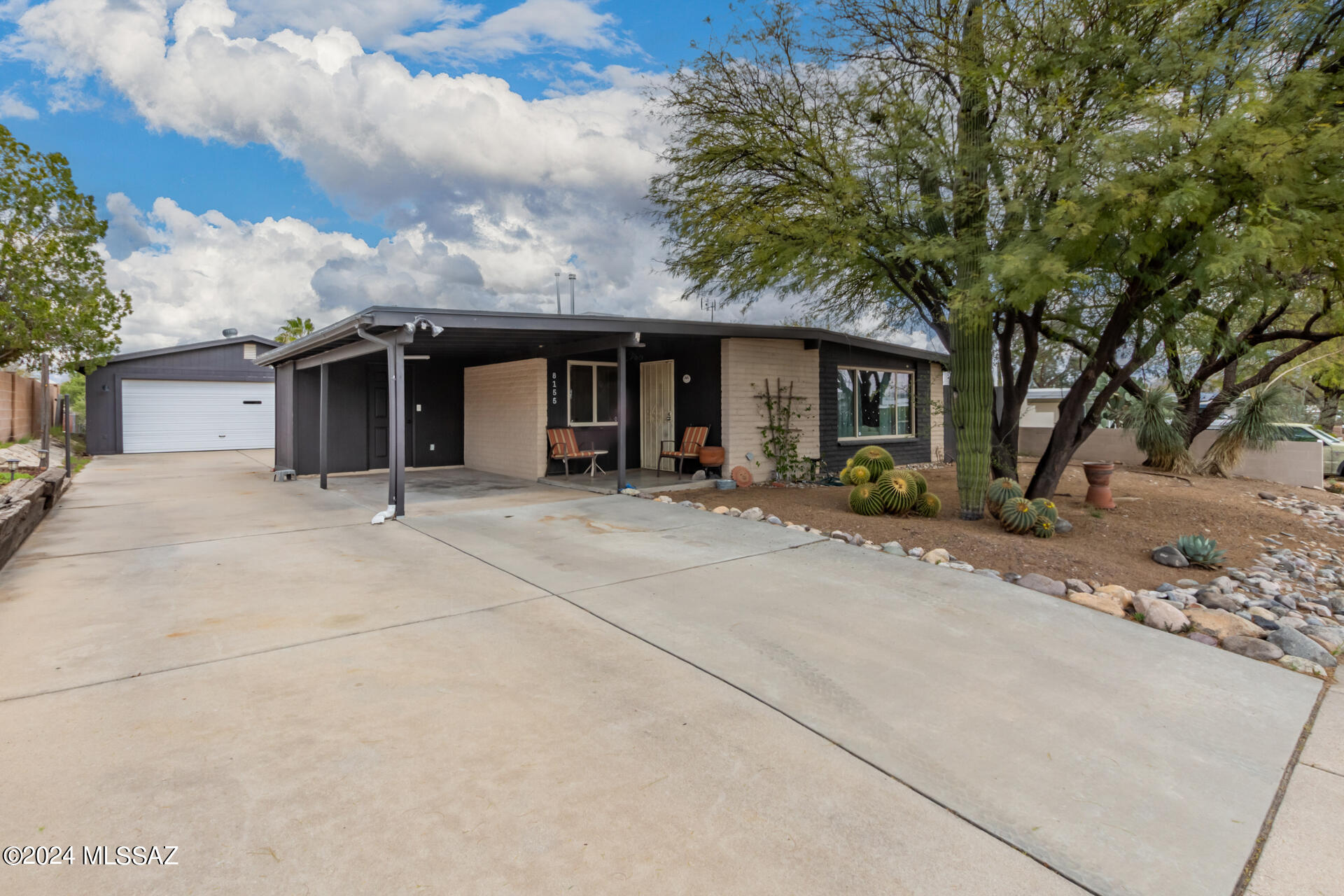 Welcome to this charming four-bedroom, two-bathroom home nestled in East Lakeside. Surrounded by mature trees, a saguaro, and natural desert landscape. This property offers a peaceful oasis! As you step inside, you'll be greeted by the inviting ambiance. *New HVAC* The kitchen boasts butcher block counters, adding a touch of warmth and character to the space while providing functionality with ample cabinetry and countertop space. The detached garage offers convenient parking and storage options. The expansive backyard provides plenty cof room for outdoor activities and entertainment, making it the perfect spot for gatherings with family and friends.