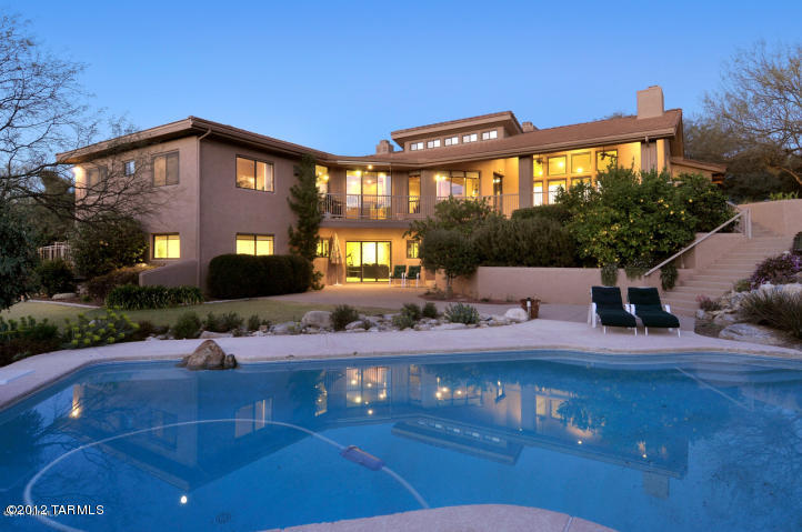 Beautiful estate home with a private resort-style backyard and amazing mountain views.  This stately 5500 square foot home includes custom tile flooring, high-end carpeting throughout, top of the line granite slab, custom backsplash and stainless steel appliances in the kitchen.  The floor plan is versatile and inviting.  The main level holds 3 bedrooms plus an office and living areas, while the lower level encompasses 3 additional bedrooms, full bath and an abundance of storage areas.  A pool fence has been added.  Located within District 16 schools and a short drive or walk to Sabino Canyon, shops, restaurants and more.