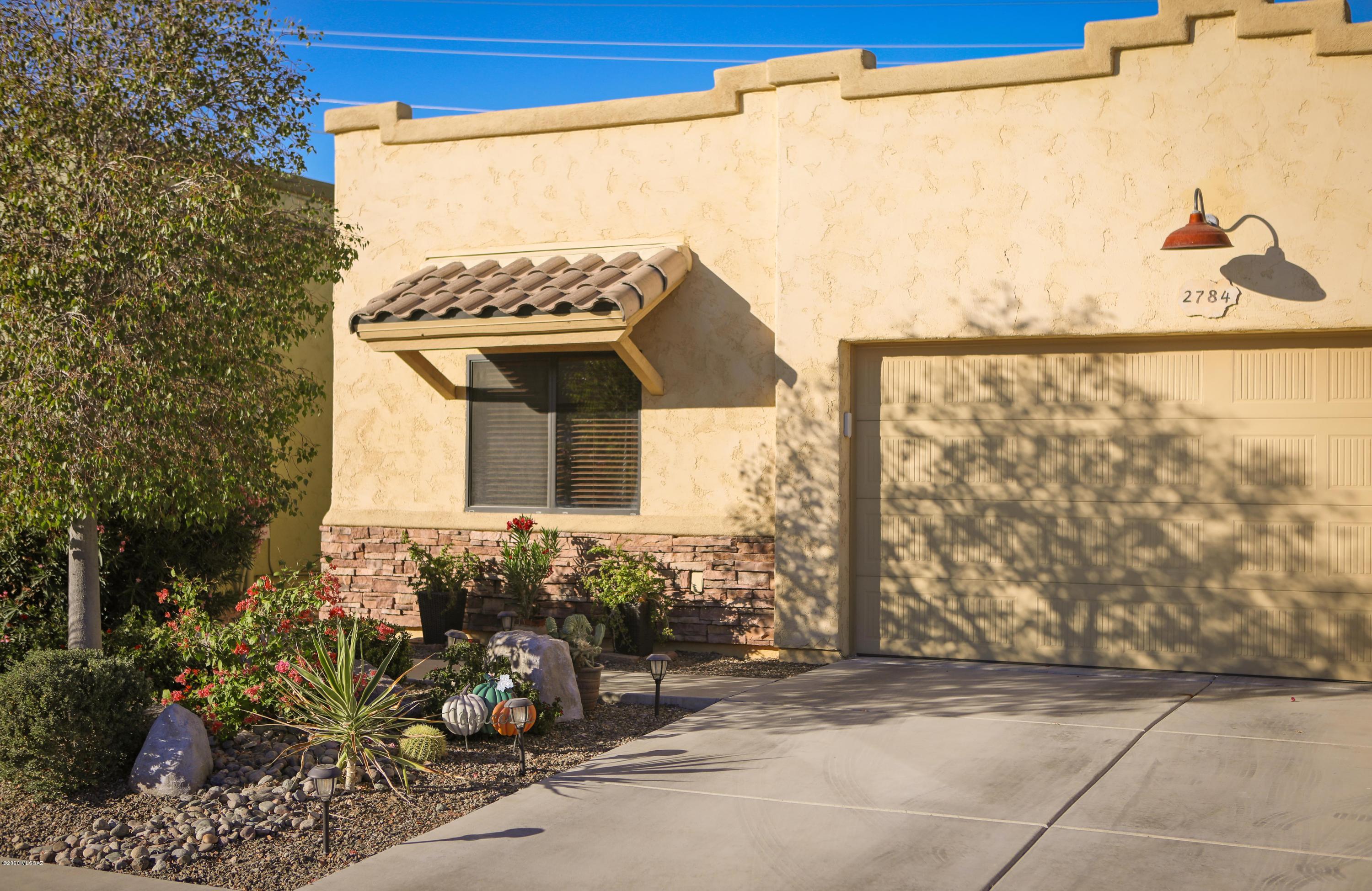 Gorgeous move in ready home located in the popular gated community of Silverbell Vista. This 1668 sqft open floor plan home is with upgrades including high ceilings, granite countertops in kitchen & bathrooms, GE Slate finger proof appliances, new interior paint (including ceilings & garage, upgraded carpeting in bedrooms, surround sound in all rooms & patio, overhead garage storage, full length covered patio with decorative ceiling fans, flagstone pavers & much more. Won't last long. One seller is a licensed AZ real estate agent.