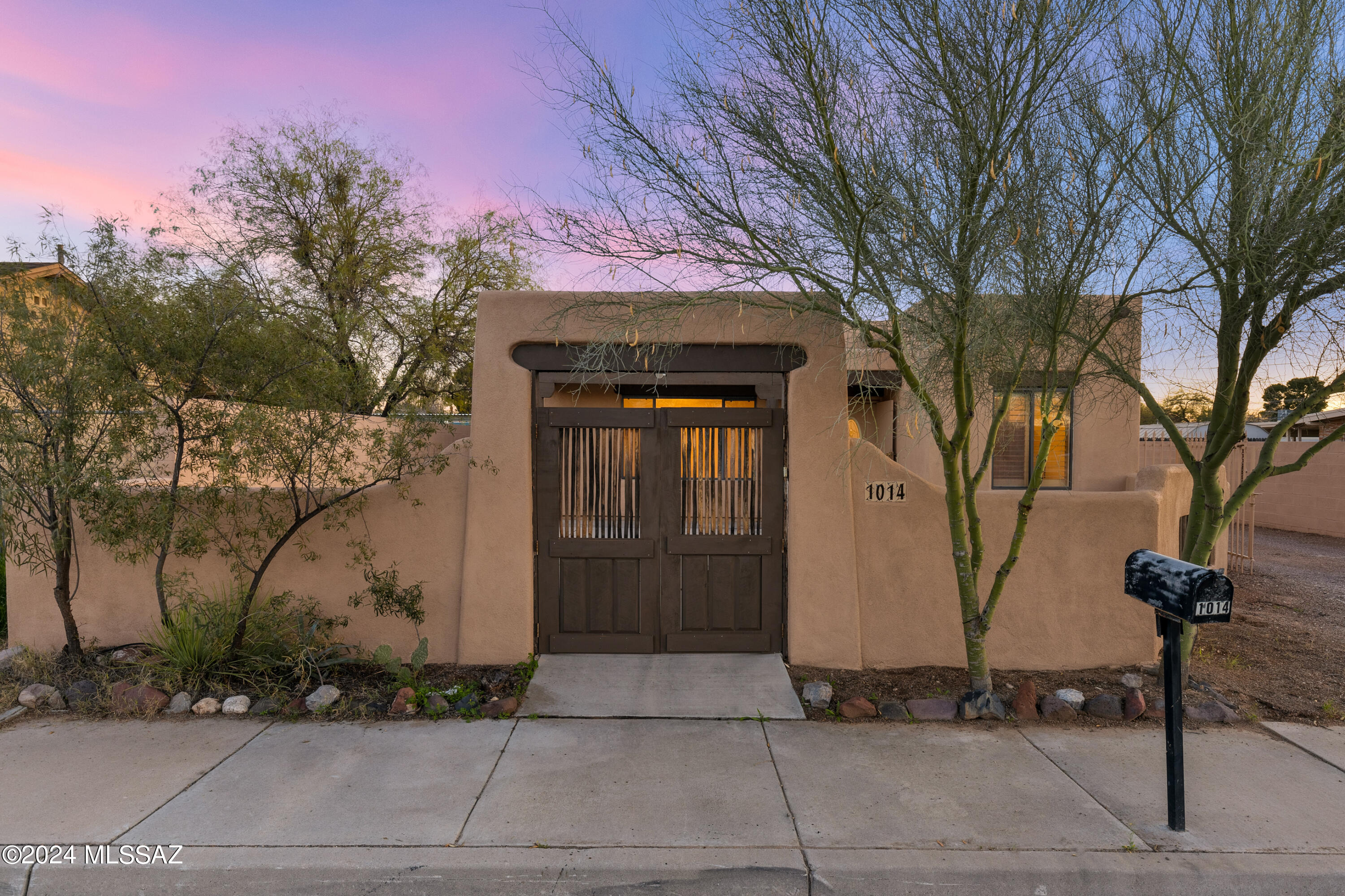 Immaculate 2001 house & guest house w/ 2-car garage & 3 covered parking spaces located just off of the Mountain Ave bike path, 3.5 miles from the U of A. So many options w/ this conveniently located property: Live in one & rent out the other, long-term or Air BnB, use the GH as an office/flex space, or accommodate multigenerational living. Charming walled & gated courtyard w/ a covered patio. 1304 sf main house has 2 bedrooms & 1 bathroom with dual sink vanity & tub/shower. Spacious kitchen,  ceramic tile thruout, no carpet, ceiling fans & custom shutters. Spacious laundry room. 447 sf GH w/ kitchenette & full bathroom. W/D hookup. Covered storage area. Low care: no landscaping maintenance required. Minutes to Trader Joes, the Loop 131-mile connected bike path, farmers markets, and more.