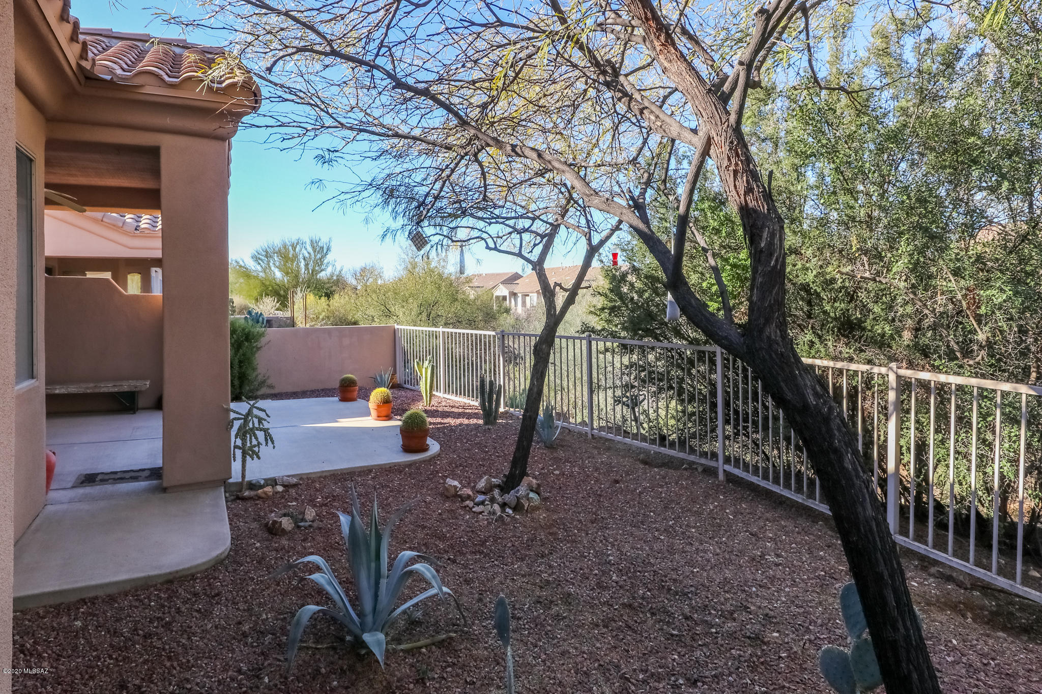 Contemporary, single-level patio home in gated active-adult community of Vistoso Village - the perfect setting for seasonal or year-round living! Split Bedroom Plan leaves this home feeling spacious and cozy. Open living area highlighted by soaring vaulted ceilings and an abundance of natural light from the windows overlooking the serene backyard. Curved breakfast bar overlooks a functional kitchen with matching black appliances in new condition (purchased in 2005 & only used for 2 weeks per year ever since) and counterspace galore. Backing to coveted natural desert open space, you'll love the added privacy and views from your extended covered patio. Enjoy a host of amenities including... a lap pool, recreational pool/spa and a beautiful clubhouse featuring an exercise room, library & all-purpose recreation room.