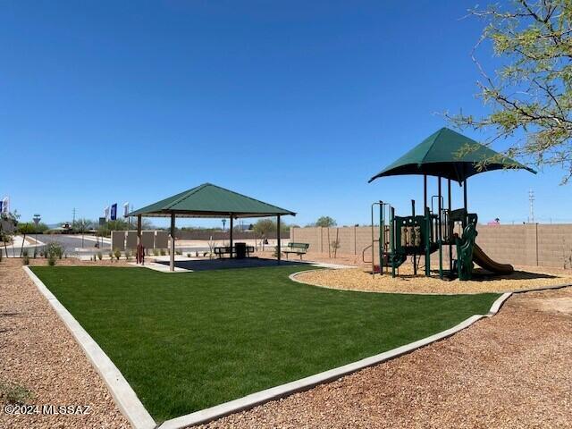 Welcome to Senita Crossing, where spacious living meets convenience! Our newest Tucson community boasts this open floor plan ideal for modern living. Enjoy the perks of a community park just steps away, with easy access to I-10, DMAFB, TIA, University of Arizona, and Downtown Tucson. Inside, you'll find a host of premium features, including stainless steel appliances (microwave, dishwasher, gas range), walk-in pantry, white shaker cabinets, granite countertops, and tile flooring in most areas. Say goodbye to cold showers with a tankless water heater and embrace the future with smart home technology. Plus, enjoy the convenience of water filtration at the kitchen sink and the added efficiency of a radiant roof barrier. Don't miss out on the opportunity to make Senita Crossing your new home!