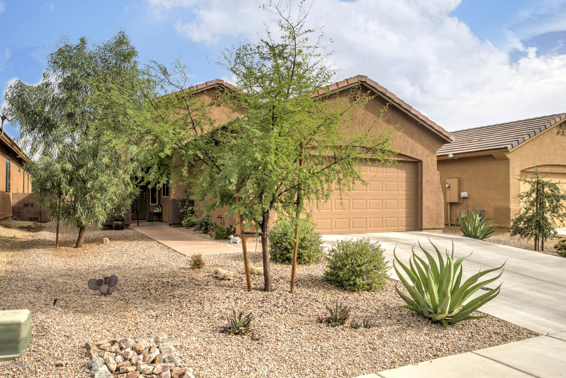 Very attractive two-year old home on elevated lot in La Campanas, close to all shopping in Green Valley. Spacious open backyard with extended paver patio. A beautiful setting for morning coffee or an evening dinner. The interior has upgraded designer style cabinets in kitchen and baths. Granite countertops compliment the cabinets. The appliances are high-end grade and stainless steel to boot. Ceiling fans in great room and bedroom. Front loading washer and dryer in spacious laundry room with a window. Interior painted in very complimentary designer soft colors. Maser bedroom and bath with dual sinks, large walk-in shower and spacious walk-in closet. Two picture frame mirrors over the master bath counter. The second bedroom in split bedroom floor plan has a bathroom adjacent to it.  The den/library is off the entry and open to the great room. Full two-car garage. Water softener. Very attractive desert landscaping. Whole house was tastefully done with attention to detail you will appreciate.