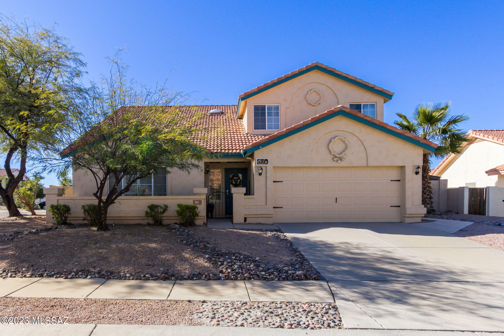 Discover your perfect getaway in this all-season east-side home. Enjoy lazy summer days lounging by the pool or cozy winter nights by the fireplace. Entertain in style with the formal living & dining rooms and a Spacious eat-in kitchen. The surrounding area offers endless opportunities for adventure, from visiting Saguaro National Park, Sabino Canyon, and Mount Lemmon. You'll find practical conveniences on the main floor, such as a walk-in pantry, powder room, and laundry room. Upstairs, the spacious four bedrooms provide a peaceful escape, including an oversized primary bedroom with a walk-in closet, an en suite bath with dual vanities, and stunning views from the guest bedroom balcony on the second floor. Don't miss this opportunity to unwind in comfort and style!