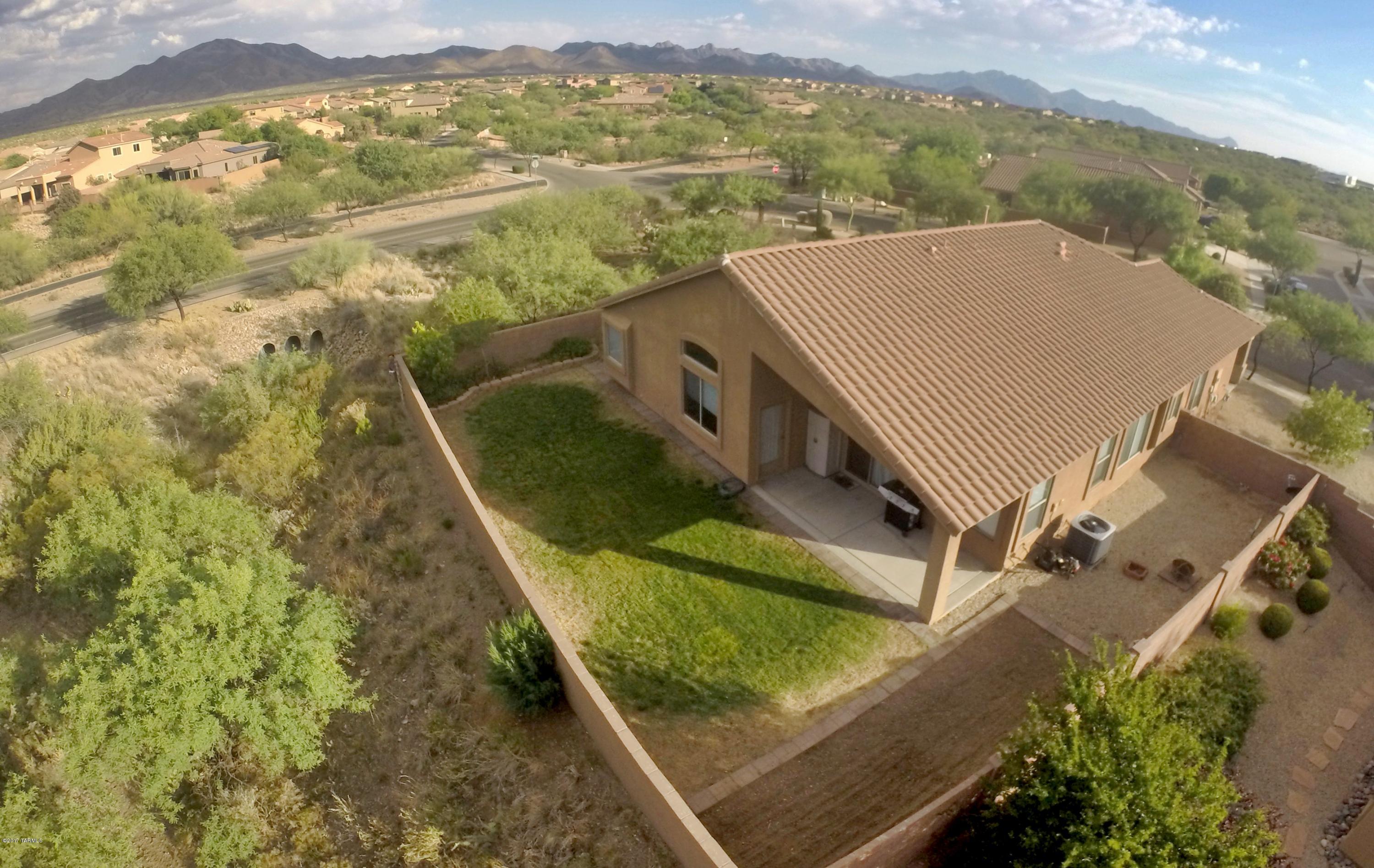Privacy is the key word here.  In the heart of the desirable Sycamore Canyon Subdivision just up the street from Vail School Districts newest elementary school.  This 4 bedroom 2 bath home is on a corner lot with nothing but views out your backyard.  Huge Master bedroom with access to the backyard.  Large open kitchen with huge island and pantry. Covered front porch and double gate are just a few of the highly sought after amenities that this single story home posses.