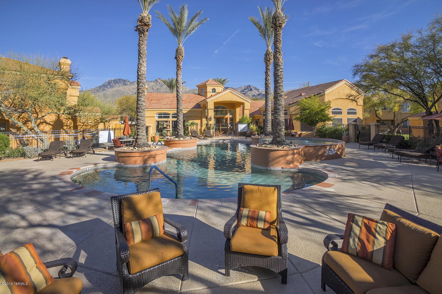 Spacious ground floor condominium in the gated Catalina Foothills community of Pinnacle Canyon.  This Northern Tucson property is conveniently located near shopping, numerous restaurants and Sabino Canyon Park and features an open floor plan with split bedrooms, 2BR/2BA, 1048 square feet, fireplace, covered screened in patio, all appliances including washer / dryer, water / sewer / trash all included with rent, no carpeting, covered parking and resort style amenities.  The Pinnacle Canyon Condos include a heated pool & spa, exercise facility, enormous clubhouse and park-like grounds.