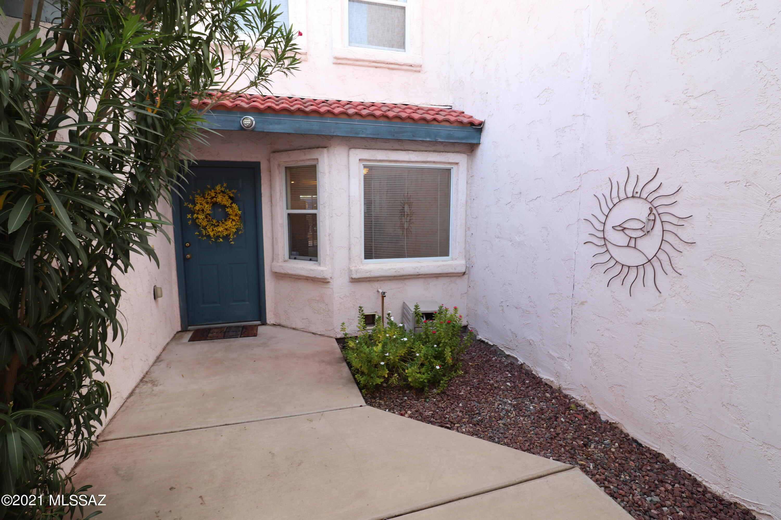 Welcome to this beautiful 3BR/3BA Sam Hughes area townhome updated with granite countertops in the kitchen. Enter thru your own gated courtyard and soak in the privacy. The large living room features a fireplace & looks out on the back patio with a stunning mosaic tiled wall. The spacious floor plan features 2 master suites with full bathrooms, and one bed & bath downstairs that could also be a great office. Storage abounds under the stairs and inside the 2 car garage with a built in work area & overhead storage. Relax in the refreshing community pool & spa maintained by the HOA. Encanto Court is a real gem with lushly landscaped common areas and sidewalks throughout. Close to the UA, shopping, restaurants, parks, movie theatres & TMC. RENTALS ALLOWED BY HOA. Open Saturday August 7th 9-12.