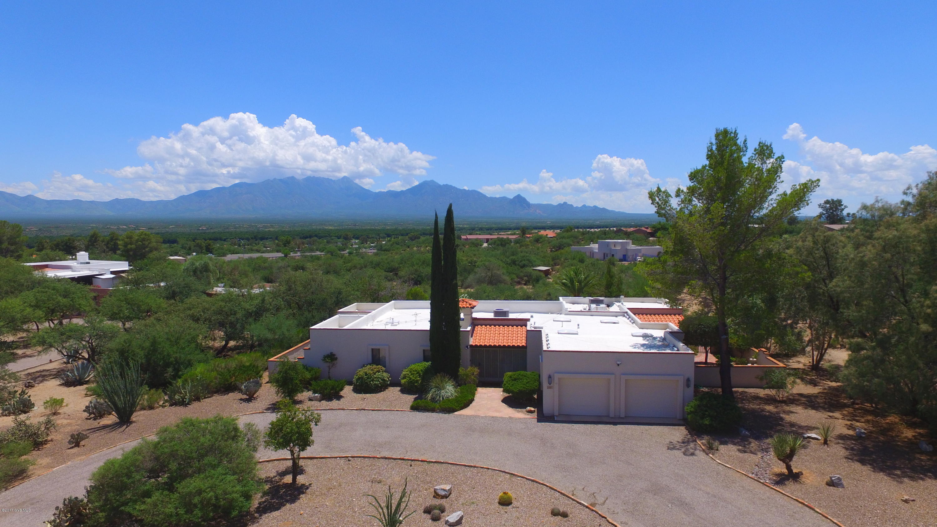 Glorious home on a stunning 1+ AC lot. Magnificent views and excellent living spaces. This custom home has 3 bedroom suites. 1) Master with a walk-in closet big enough for a celebrities wardrobe, 2) Guest Suite and 3) An attached ''Casita'' the bedroom is large, there is a sitting room w/gas fireplace and two exterior doors...one to the patio and garage the other goes to the pool. All three have there own generous size bathrooms with large showers (master also has a jetted soaking tub. The kitchen is huge! Walk in pantry, butlers pantry w/sink an island (bigger than most kitchens) all opening up to a side patio and space for casual dining or living area. When you walk through the front door the Santa Rita Mountain Range feels close enough to touch!