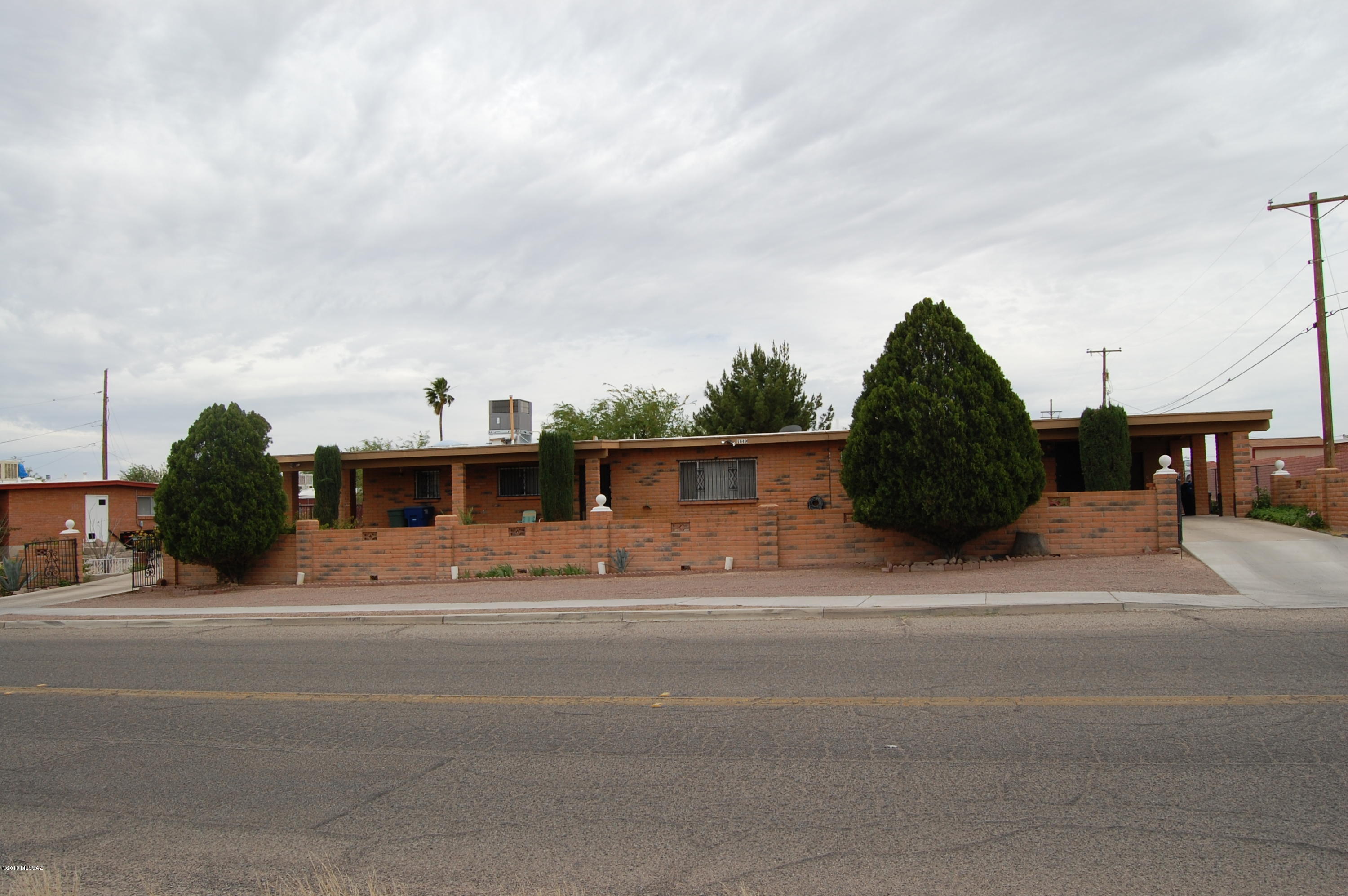 Incredible one owner home south of ''A'' Mountain with amazing views from front porch. Main house is 2 bed / 2 bath. Attached guest house is 1 bed / 1 bath with an additional bonus room. Two large storage units on each end with covered parking. Solid brick masonry. Two newer A/C units.  Huge backyard features mature fruit trees and room expand. Easy access to I-10, UA, shopping, Starr Pass and downtown. Don't miss this opportunity on this unique property.