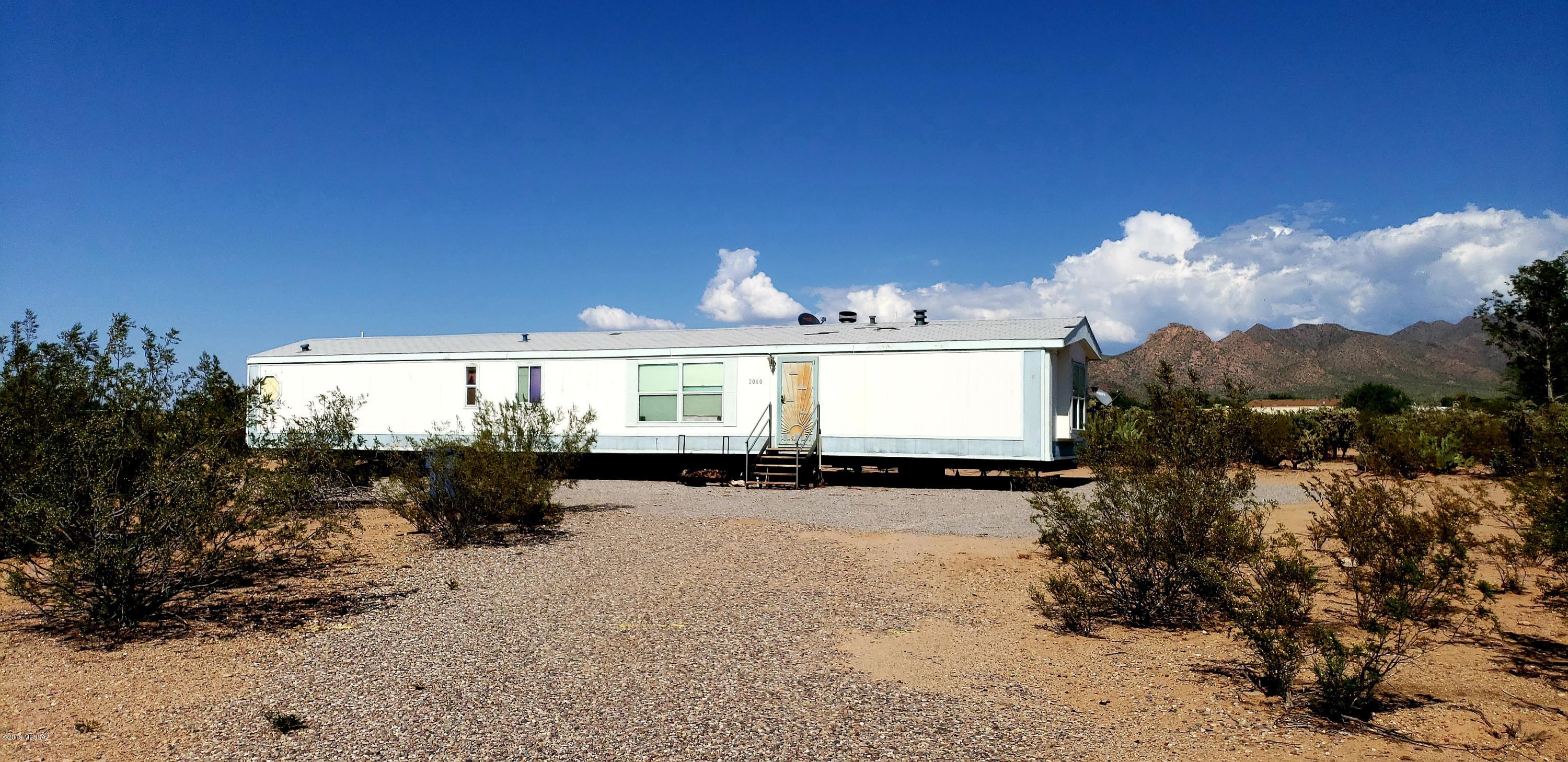 Level lot with two complete sets of MH hook-ups. Front lot has been rented to the same tenant for 12 years. The tenant OWNS the mobile home pictured in this listing. Now paying $225/mo.  This could easily be increased to be competitive with mobile home park rental fees. Rear lot is cleared and ready for a new manufactured home set-up. Access drive is along the west property line. Easy access to town.