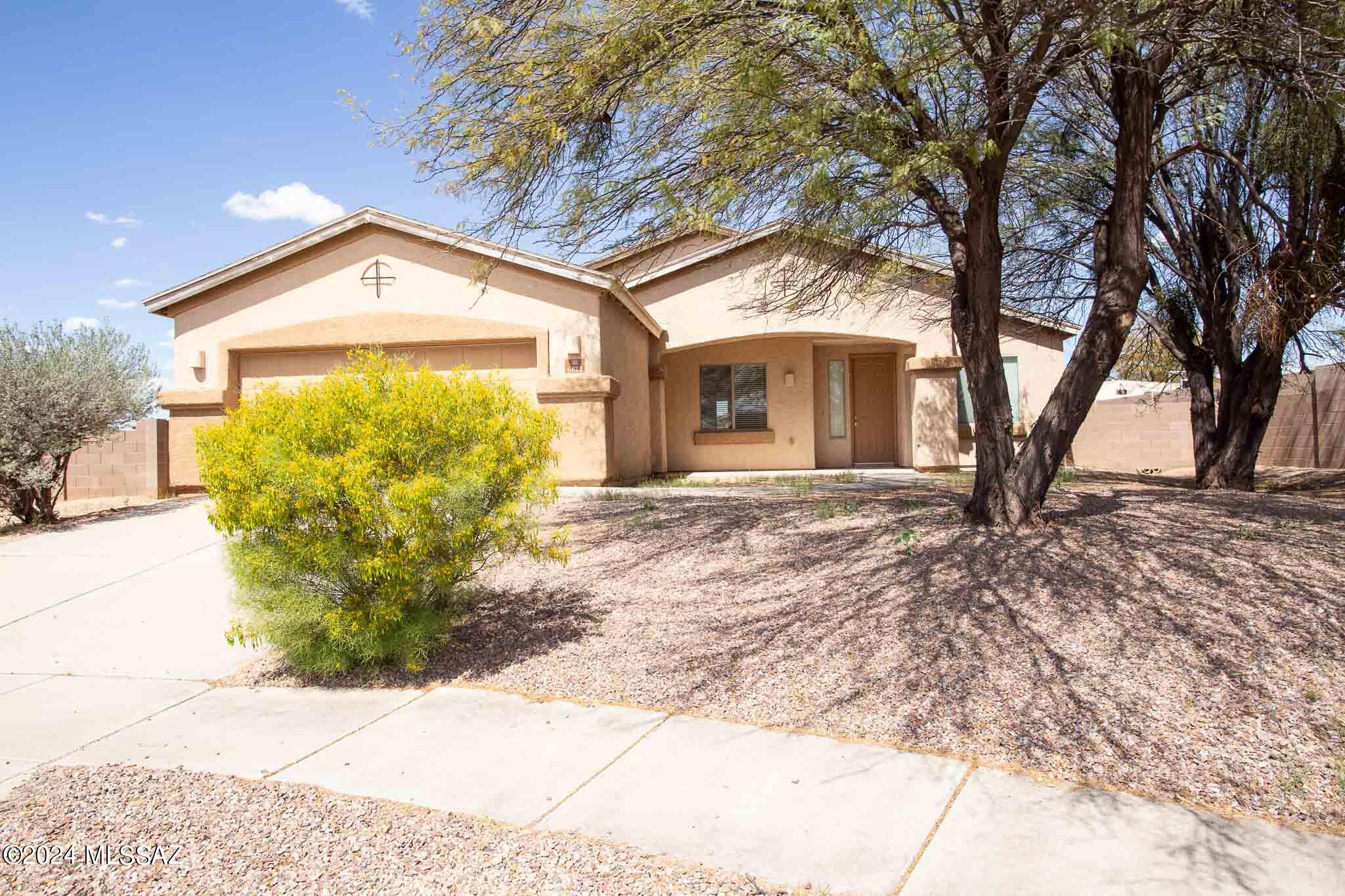 Welcome to your new home nestled in the heart of southwest Tucson! This charming property, situated on a cul-de-sac, boasts 3 bedrooms, 2 bathrooms, Living room, formal dining, 2 car garage and spacious laundry room perfect for comfortable living. The kitchen offers ample cabinet space, a convenient breakfast bar, and a cozy dining area, ideal for gatherings with loved ones. Retreat to the primary bathroom featuring a spacious walk-in closet, walk-in shower, and indulgent garden tub for ultimate relaxation. Step outside to the low maintenance backyard with a covered patio, providing a serene outdoor space for entertaining or simply unwinding. Conveniently located near shopping, restaurants, and many amenities Tucson has to offer, this property offers both comfort and convenience. Don't miss the opportunity to make this your new home sweet home!